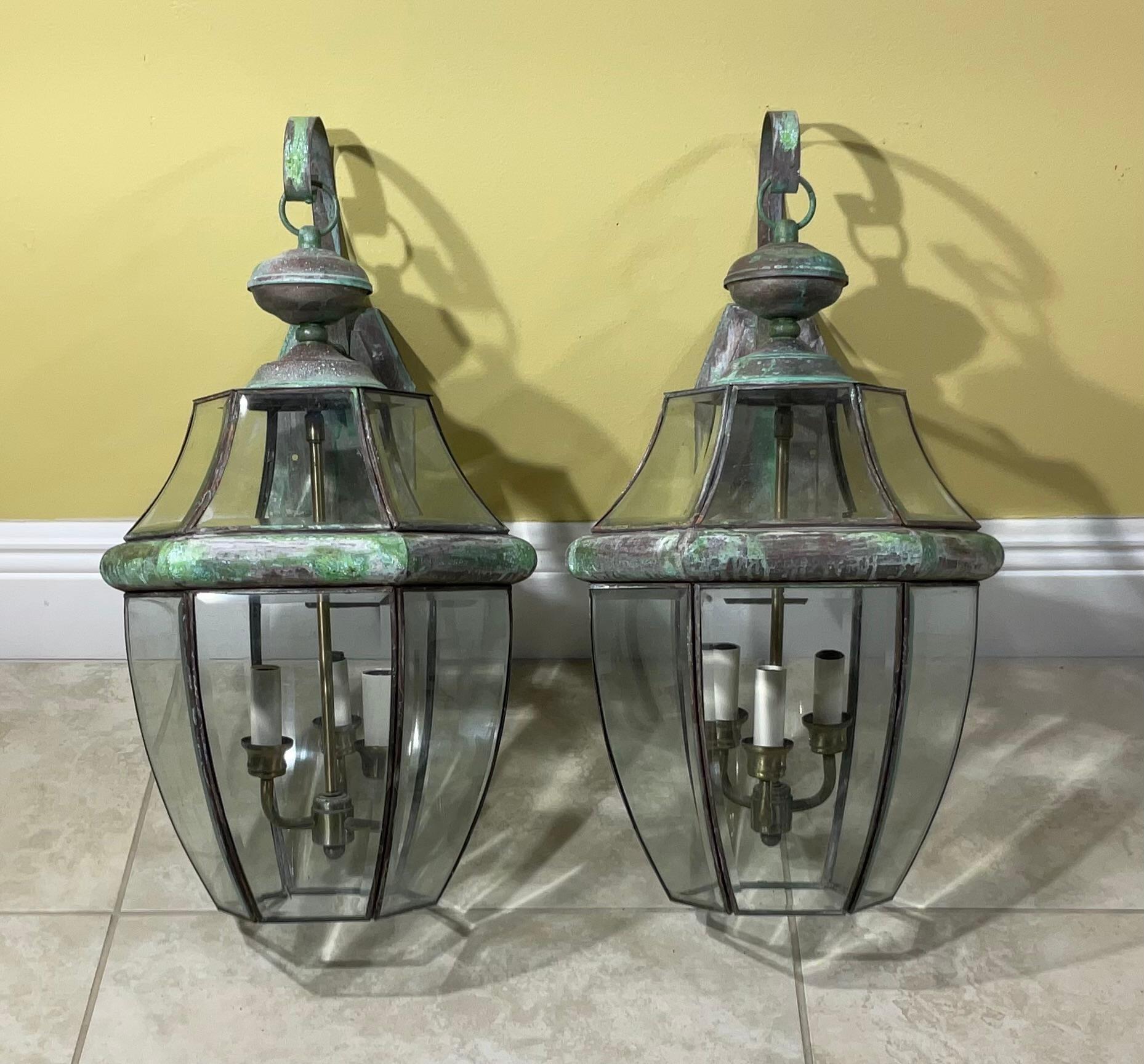 Elegant pair of wall lantern hand crafted from solid brass with three 40/watt lights each. 
 Suitable for wet locations, electrified and ready to use.
Beautiful thick beveled glass.
Decorative pair of lantern indoor or outdoor.