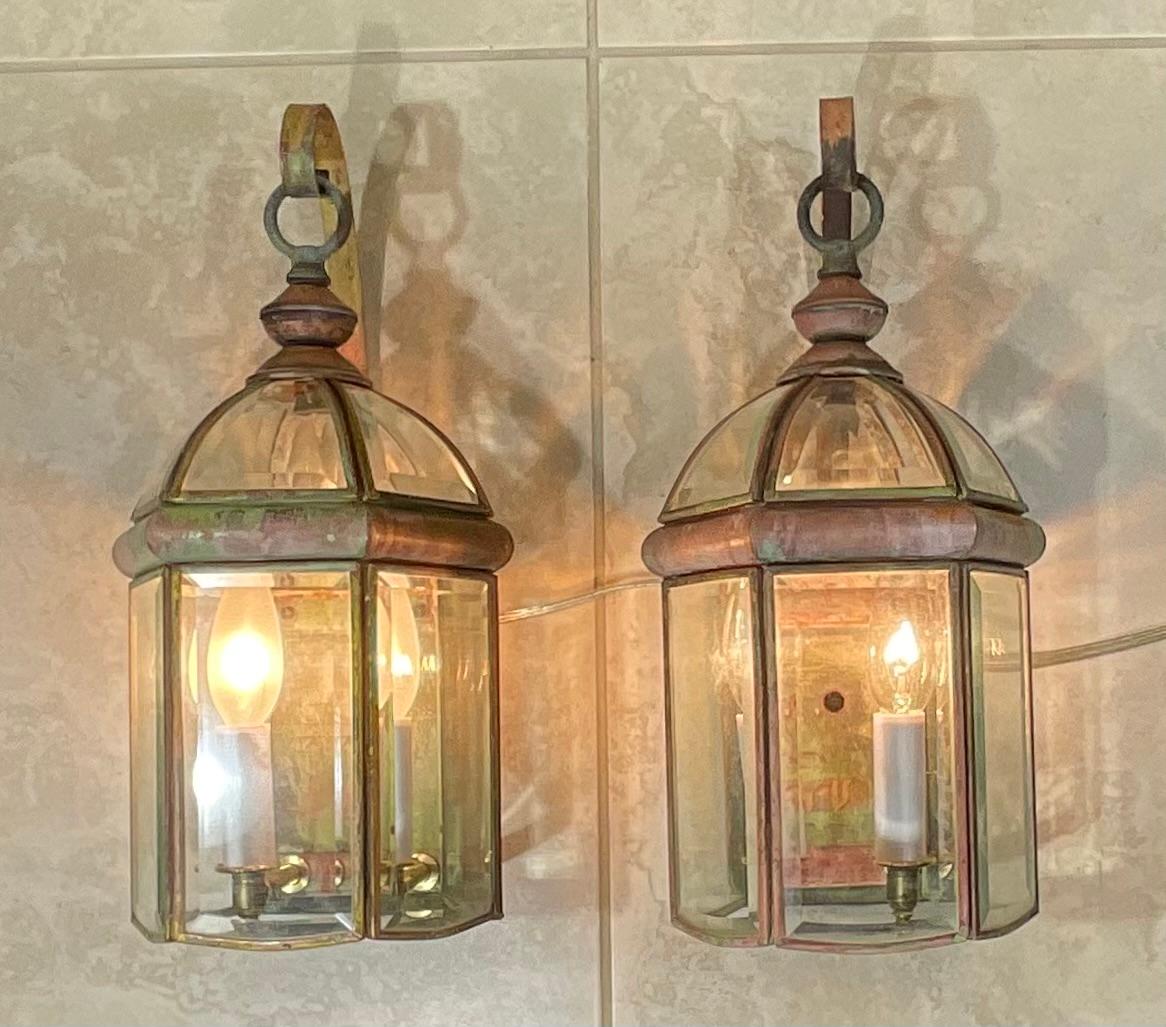 Elegant pair of wall lantern handcrafted from solid brass ,with two 40/watt light each. 
 Suitable for wet locations, electrified and ready to use.
Beautiful beveled glass.
decorative pair of lantern indoor or outdoor.
