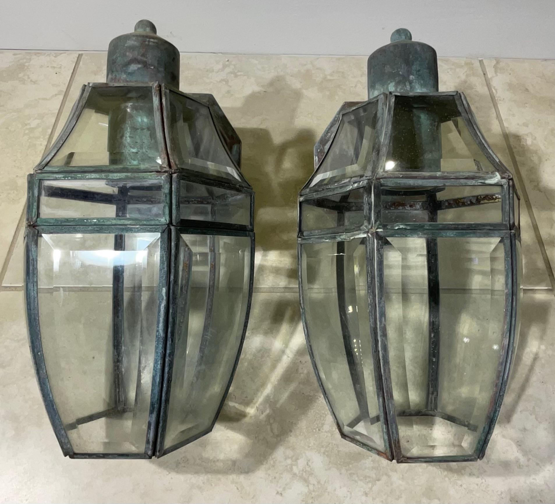 Elegant pair of wall lantern handcrafted from solid brass ,with one 60/watt light each. 
 Suitable for wet locations, electrified and ready to use.
Beautiful beveled glass.
decorative pair of lantern indoor or outdoor.