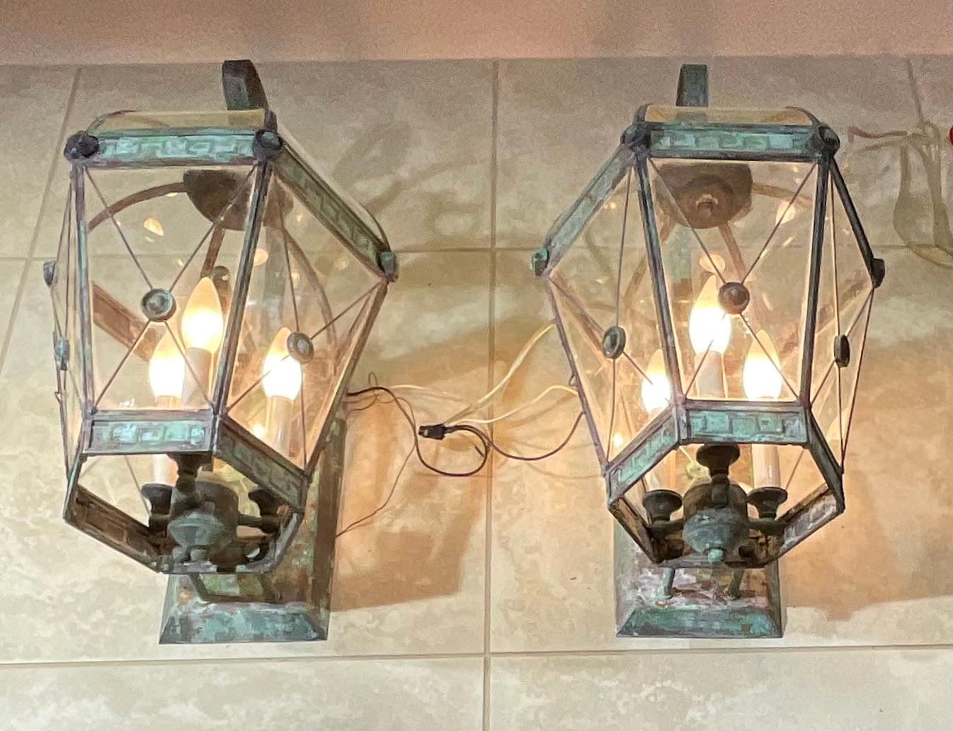 Elegant pair of wall lantern handcrafted from solid brass ,with three 40/watt light each. Decorative glass doom top, great light  exposure.
 Suitable for wet locations, electrified and ready to use.
Backplate size 12”.5 x 6”