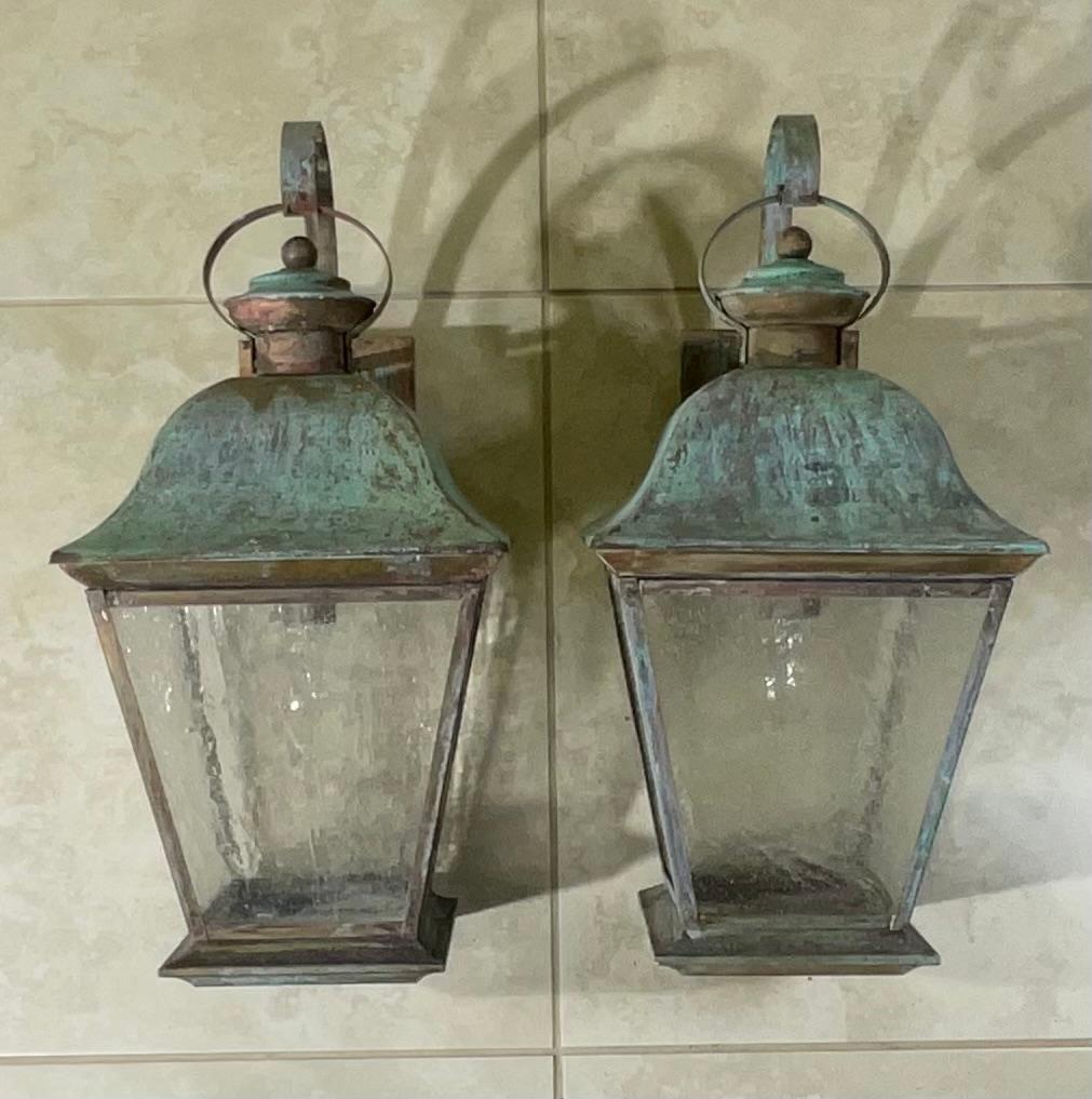 Elegant pair of wall lantern ,hand crafted from solid brass with one 60/watt light each, four sides of textured glass. Beautiful patina.
 Suitable for wet locations, electrified and ready to use.
decorative pair of lantern indoor or outdoor.