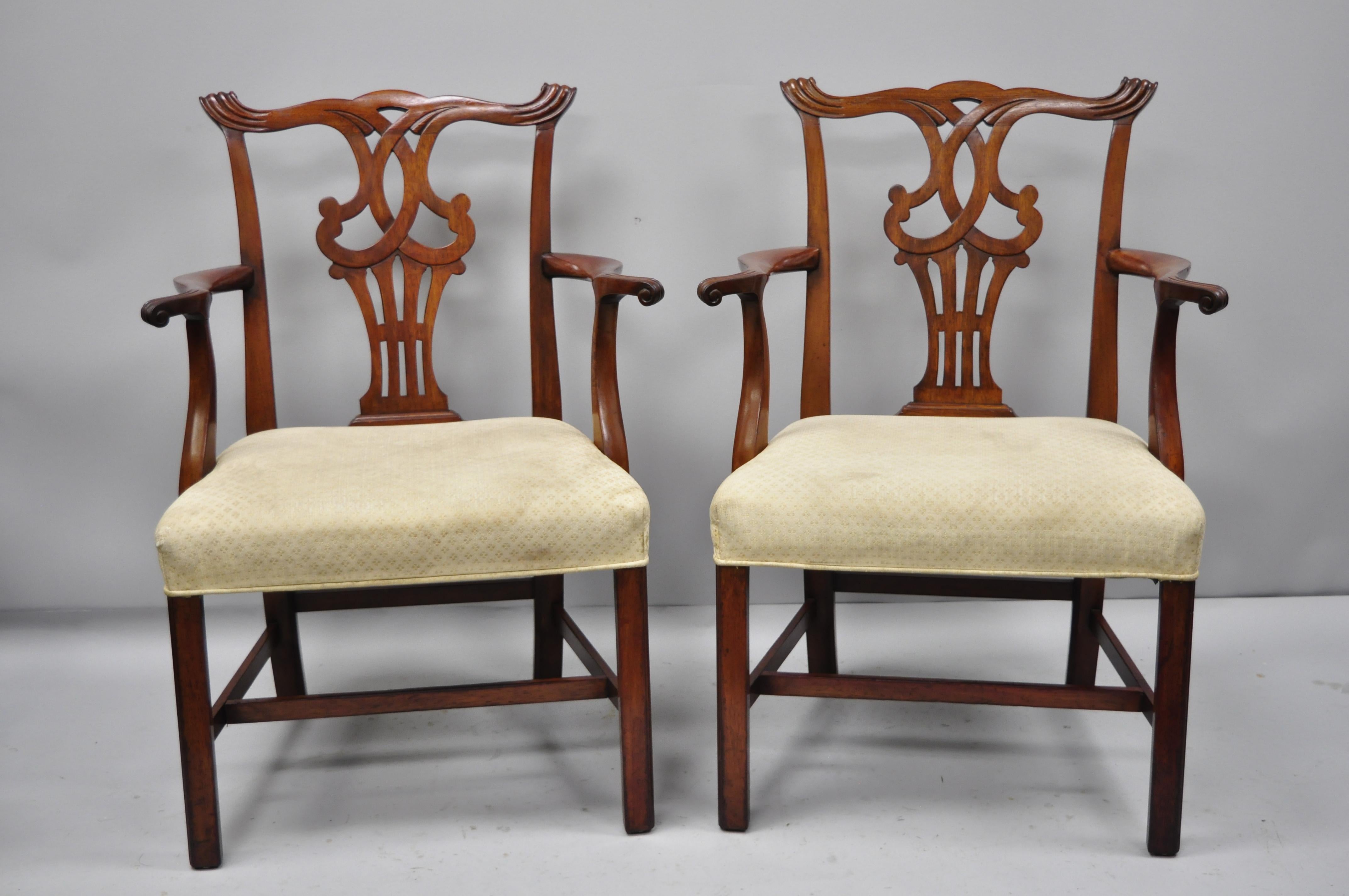 Pair of vintage solid mahogany Chippendale style dining chairs armchairs attributed to baker. Item features solid wood construction, finely carved details, and quality American craftsmanship. Attributed to baker. Early to mid-20th century.