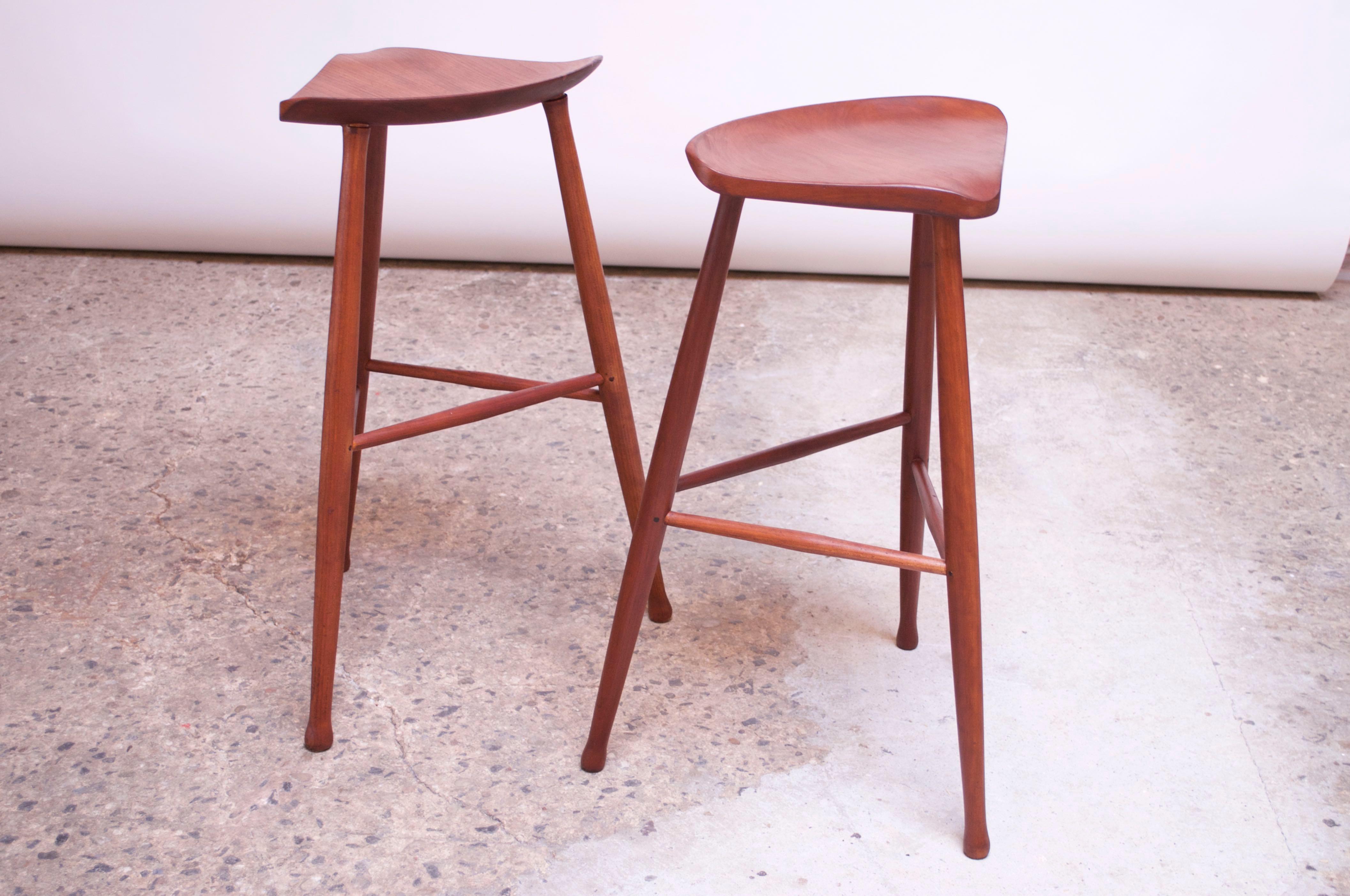 Pair of New Hope-Style walnut bar stools manufactured by David Scott in 1982. While Scott remains a noted name in woodworking today, these early, scarce examples are uniquely stylish in their minimal, modernist form, while retaining their practical,