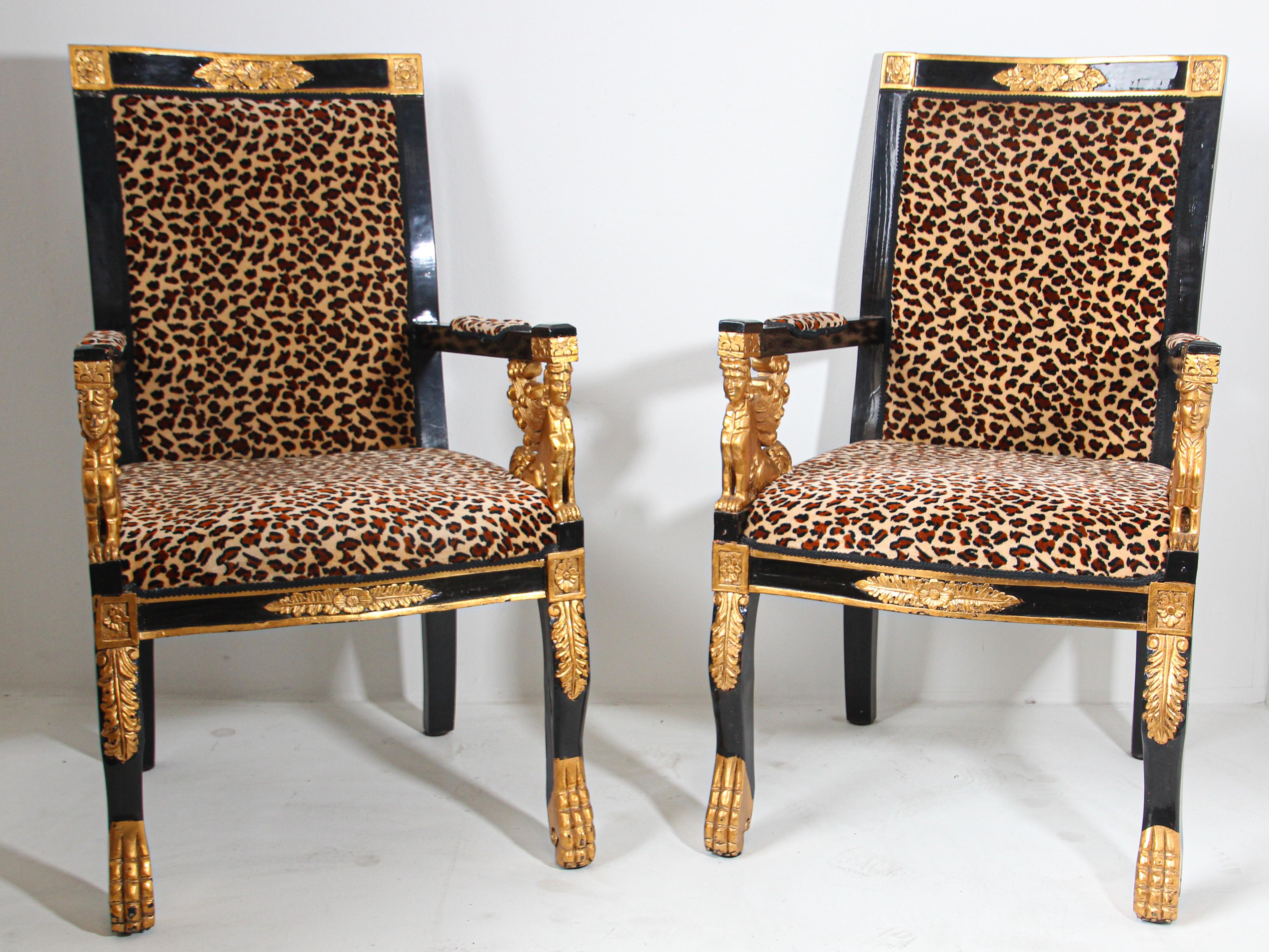 Vintage Sphinx Egyptian revival leopard print open armchairs.
This spectacular pair of Egyptian Revival open armchairs have ebonized arms attaching to gilt winged Sphinx motif arms, supported by a frame with legs terminating in gold hoof feet,