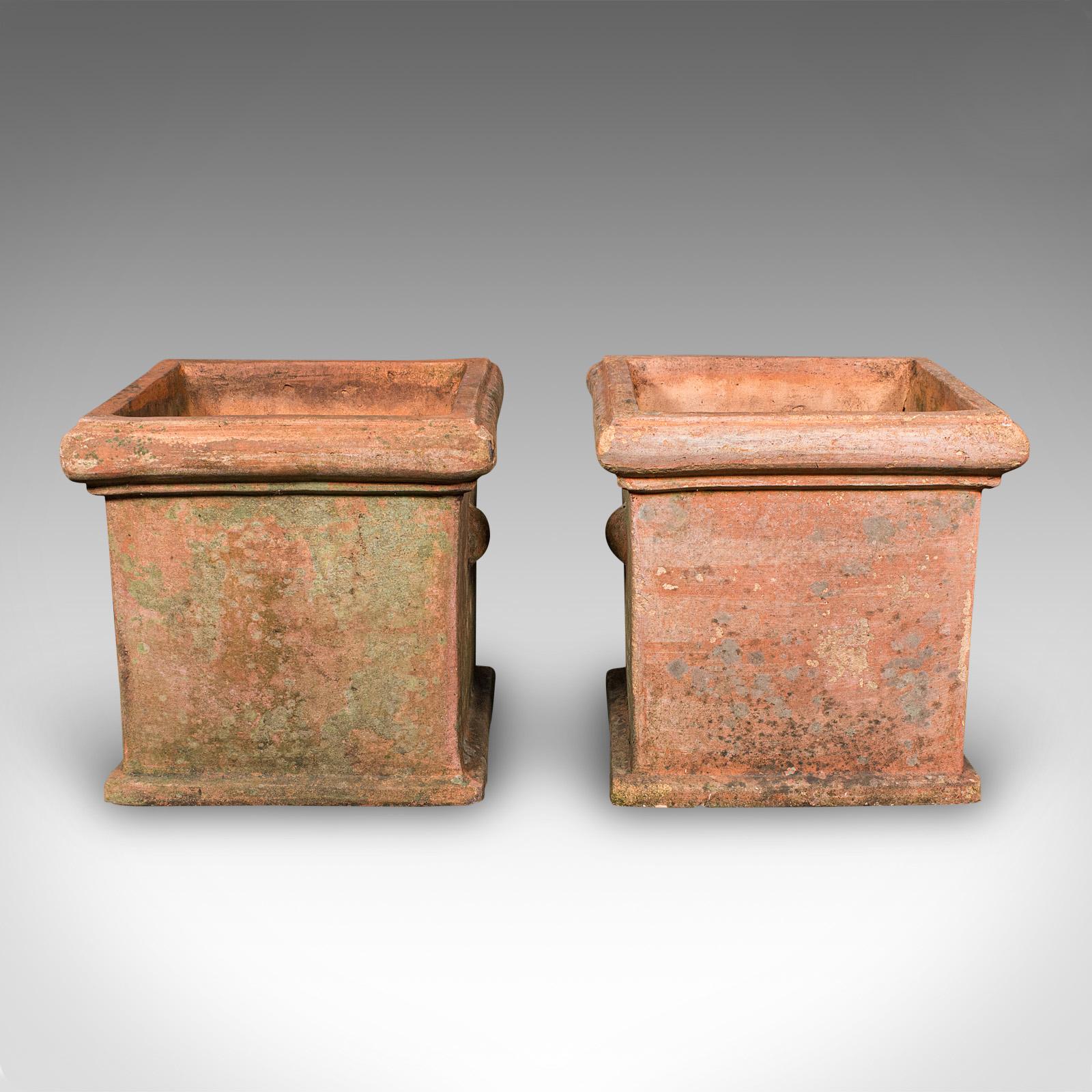 This is a pair of vintage square planters. An English, terracotta topiary jardiniere set, dating to the late 20th century, circa 1970. A charming duo, perfect for box topiary, herbs, or colourful floral displays, offering natural warmth and