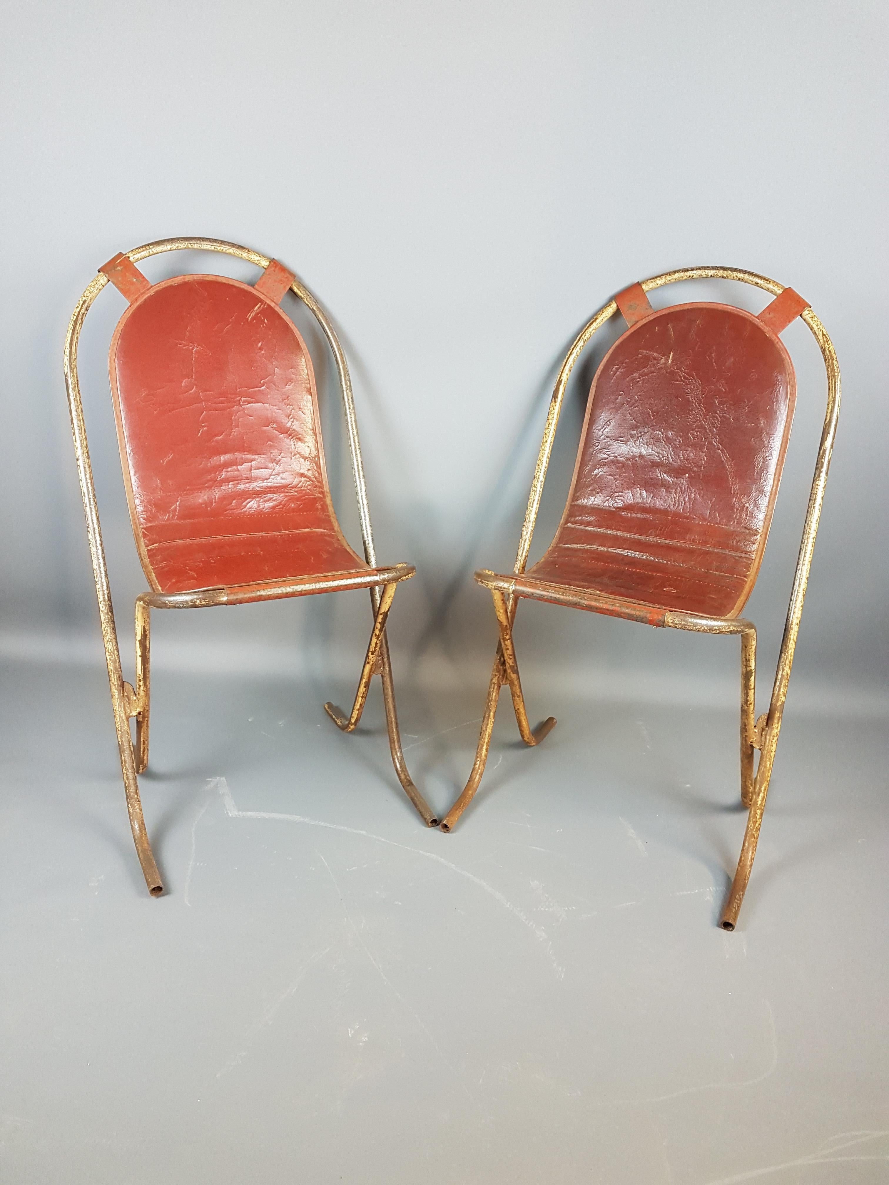 Beautiful pair of English Stak-a-Bye metal chairs by Sebel, England. With the original red rexine padded seats, the chairs are in their original paint finish with great wear and tear patina of time. These chairs have the most desirable combination