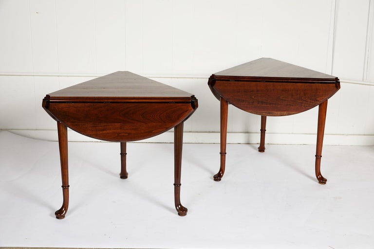 Pair of American vintage drop leaf tea or side tables in the Queen Anne style. The tables are made of solid cherry and were manufactured by Statton. Each triangular shaped table features three drop leaves that extend to form a circular tabletop. The
