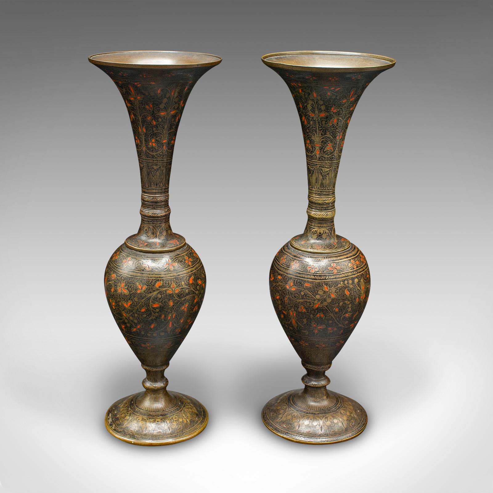 This is a pair of vintage stem vases. An Indian, brass and enamel etched flower sleeve, dating to the Art Deco period, circa 1940.

Charmingly decorative vases with a cool, tactile finish
Displaying a desirable aged patina and in good order
Brass