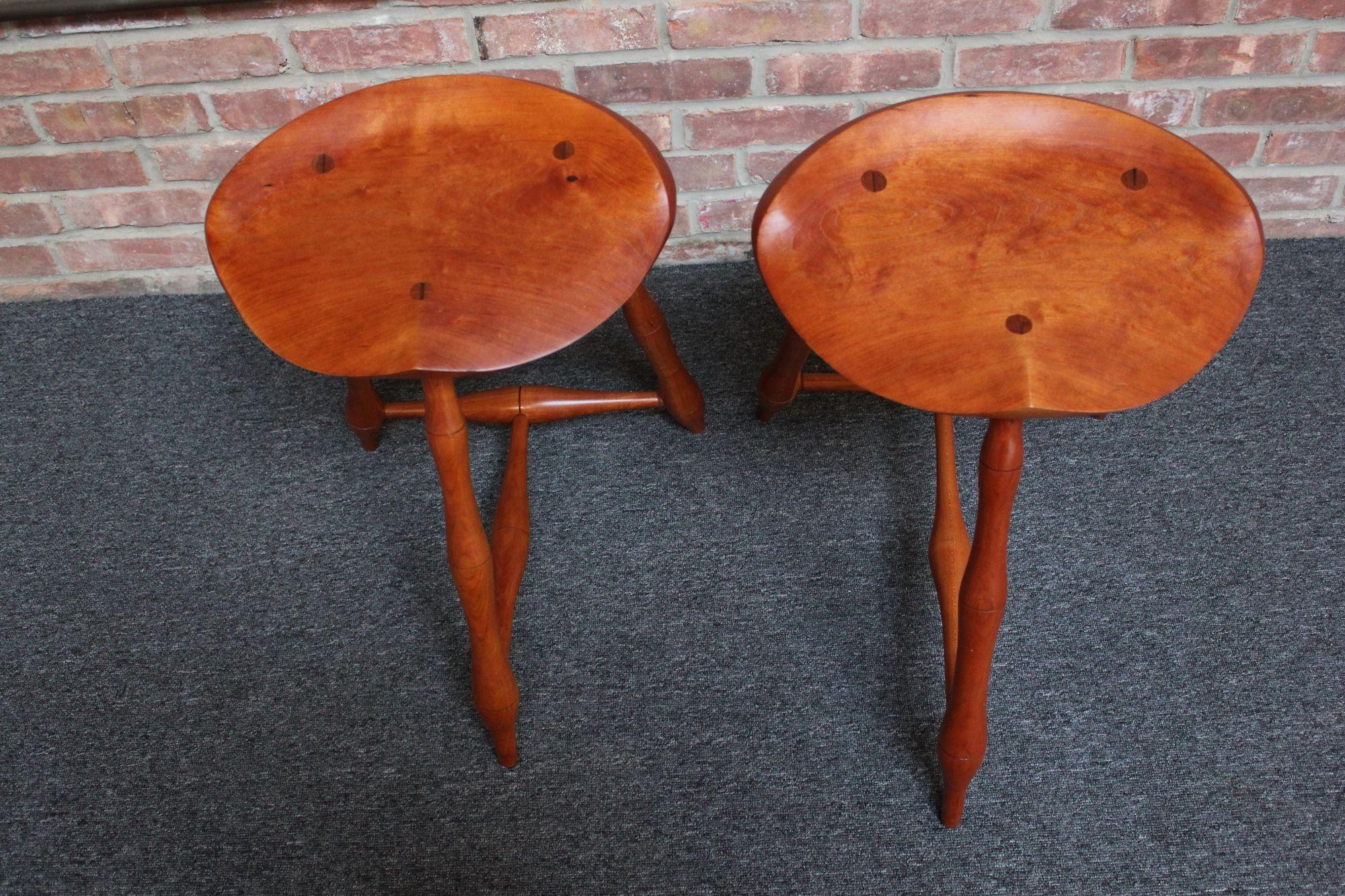 Pair of cherry wood studio craft low stools executed in a Windsor-Style (ca. 1970s, USA). Designed by a woodworker out of Syracuse, New York 