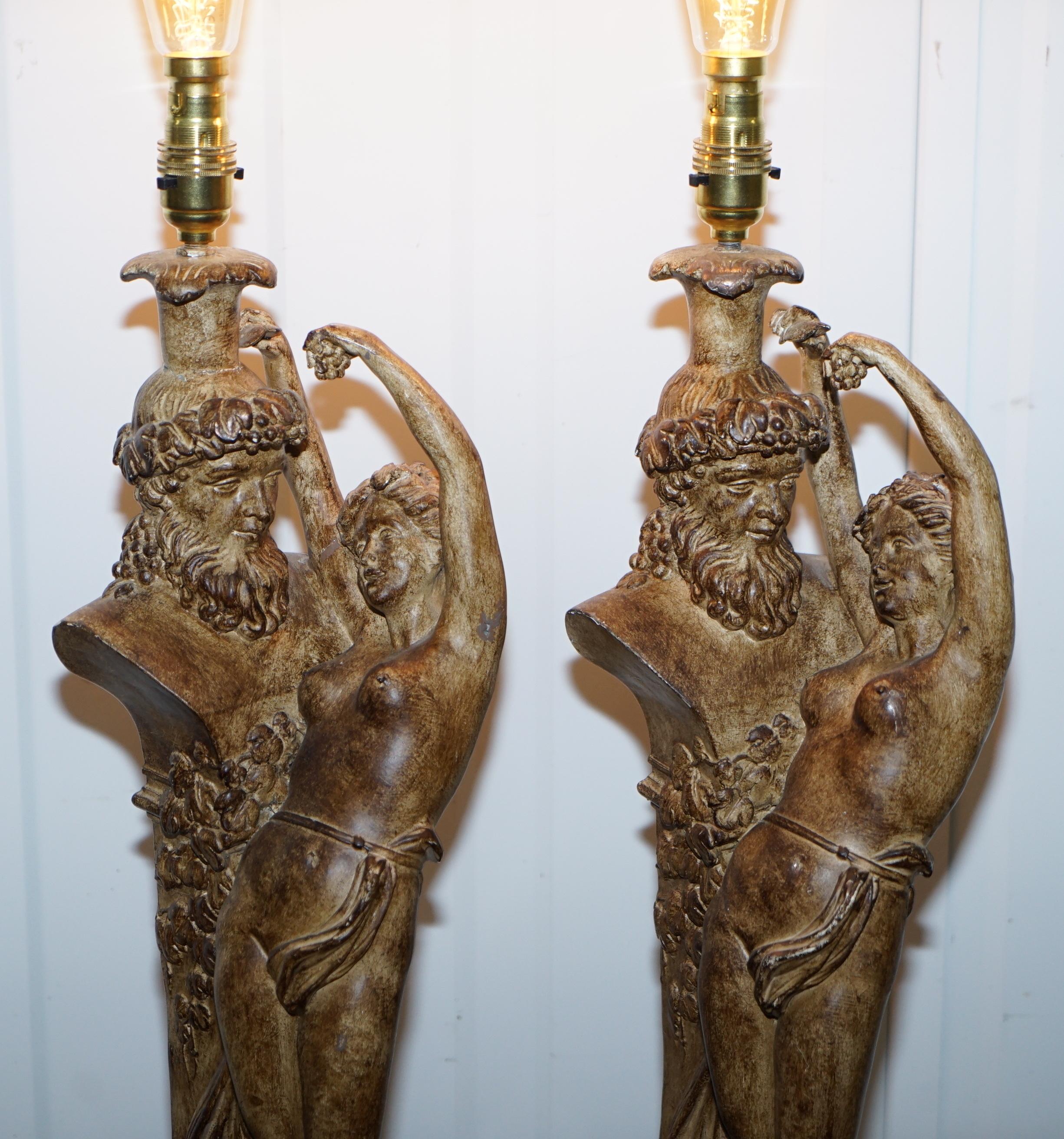 We are delighted to this very decorative pair of Roman style table lamps

A good looking pair, they each depict a maiden who looks to be seducing a statue of Zeus god of thunder 

The lamps have been fully restored with new three core flex