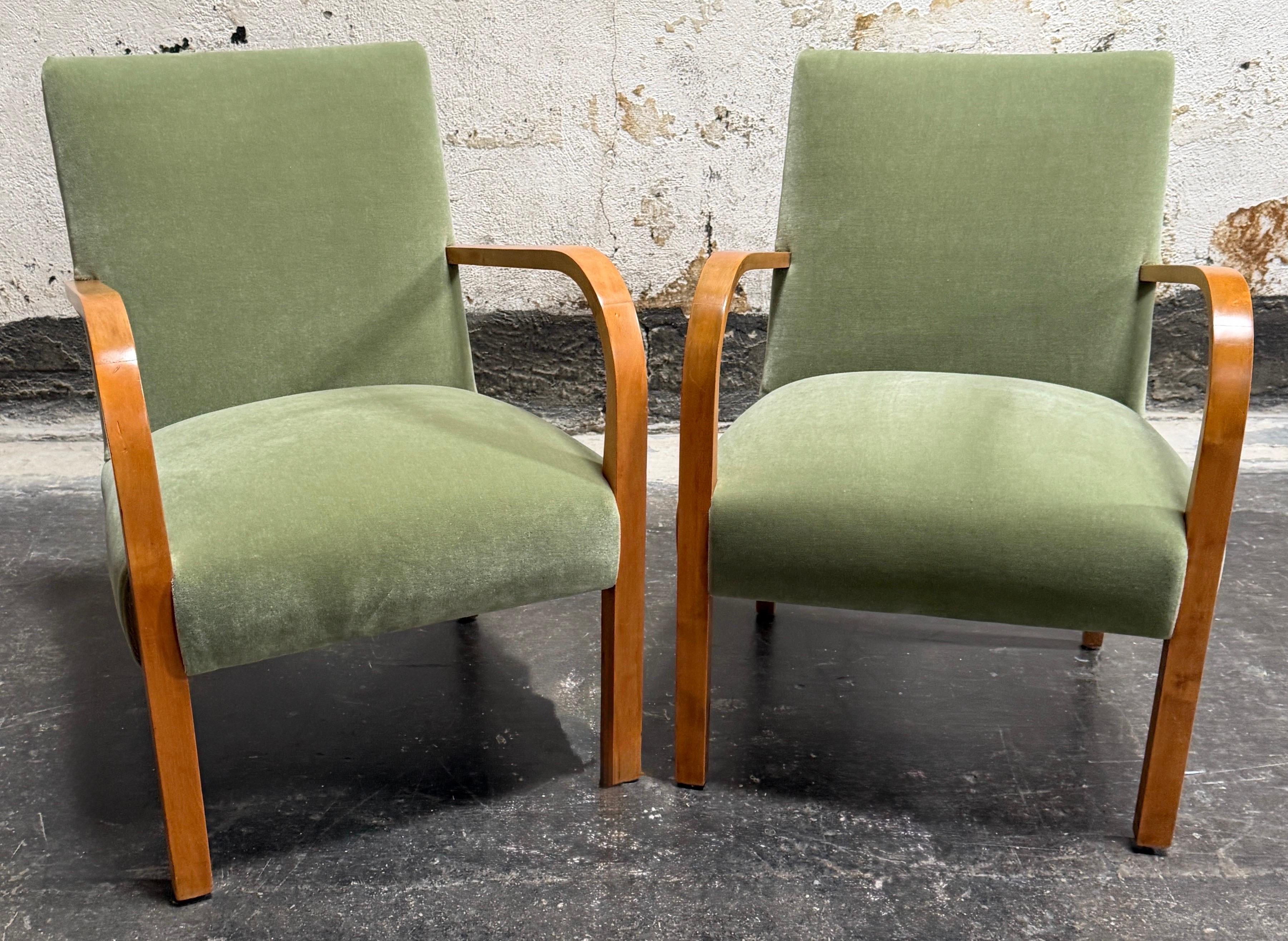 Pair of Art Deco era arm chairs with steam bent birch arms.  Sometimes also referred to as “Funkis” (Functionalist) or “Art Moderne,” as this streamlined style stripped unnecessary ornamentation and artifice and left clean lines and function. As