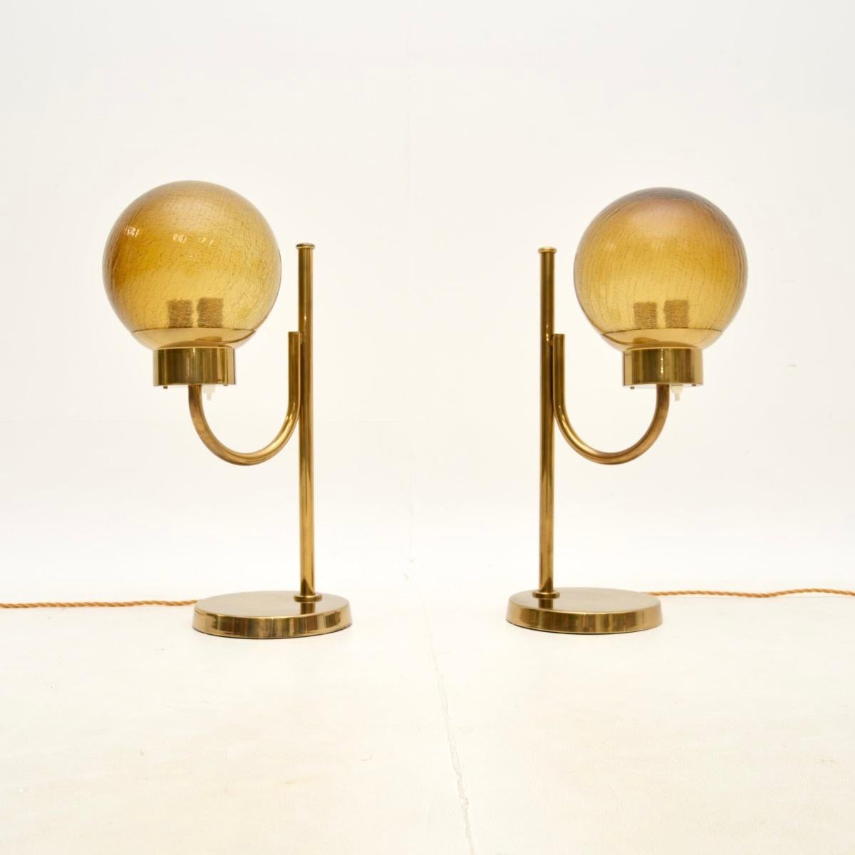 A stunning pair of vintage Swedish brass and glass table lamps by Bergboms, dating from around the 1970’s.

They are large and impressive, the quality is outstanding. The solid brass frames have a great patina and lovely design. They support