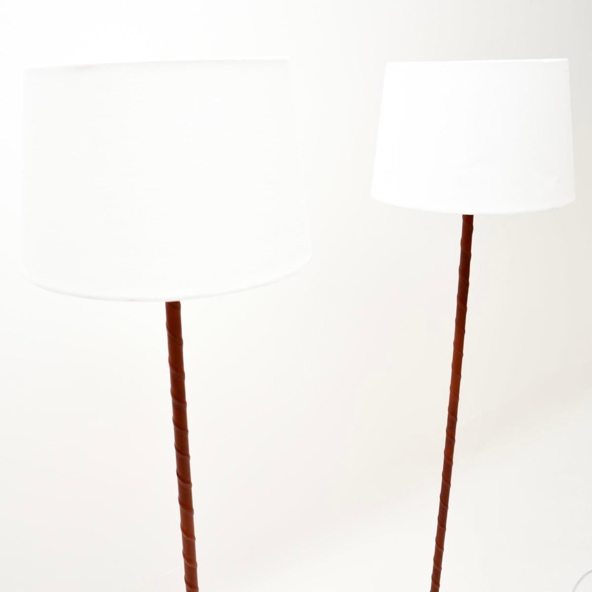 A stylish and extremely well made pair of vintage Swedish leather bound floor lamps. They were recently imported from Sweden, they date from the 1970’s.

The quality is outstanding, the metal shafts are beautifully wrapped in twisted brown leather,
