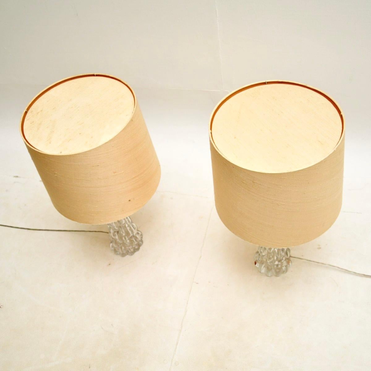 A stunning pair of vintage Swedish table lamps by Carl Fagerlund for Orrefors, dating from around the 1960’s.

The quality is superb, they are made from chunky, textured clear glass and have a wonderful tapered design. One lamp has the Orrefors