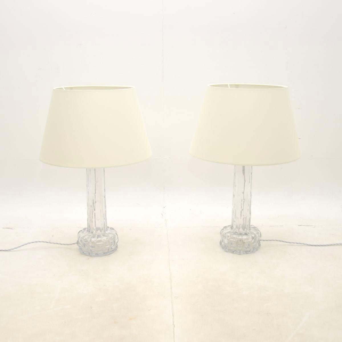 A stunning pair of vintage Swedish table lamps by Carl Fagerlund for Orrefors, dating from around the 1960’s.

The quality is superb, they are made from chunky, textured clear glass and have a wonderful tapered design. The lamps have the makers