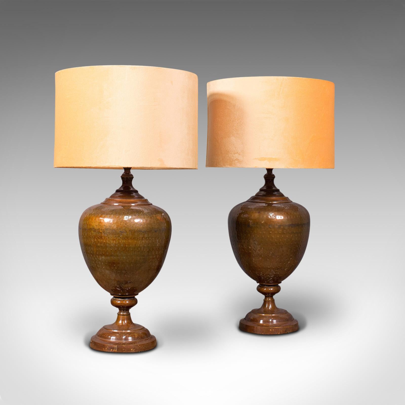 This is a pair of vintage table lamps. An English, brass decorative side light, dating to the mid 20th century, circa 1940.

Large baluster form to body with distinctive finish
Displaying a desirable aged patina - both supplied with tasteful