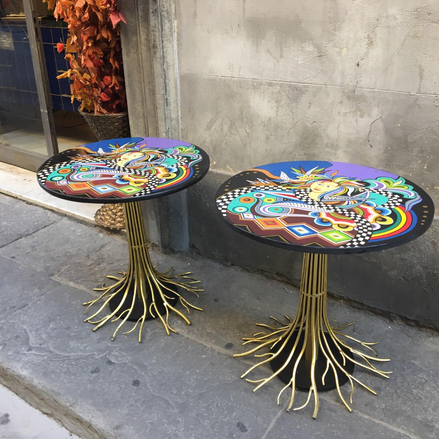 Pair of vintage round side tables with modernist style painting top, oil painted wood top, brass central leg branch effect.