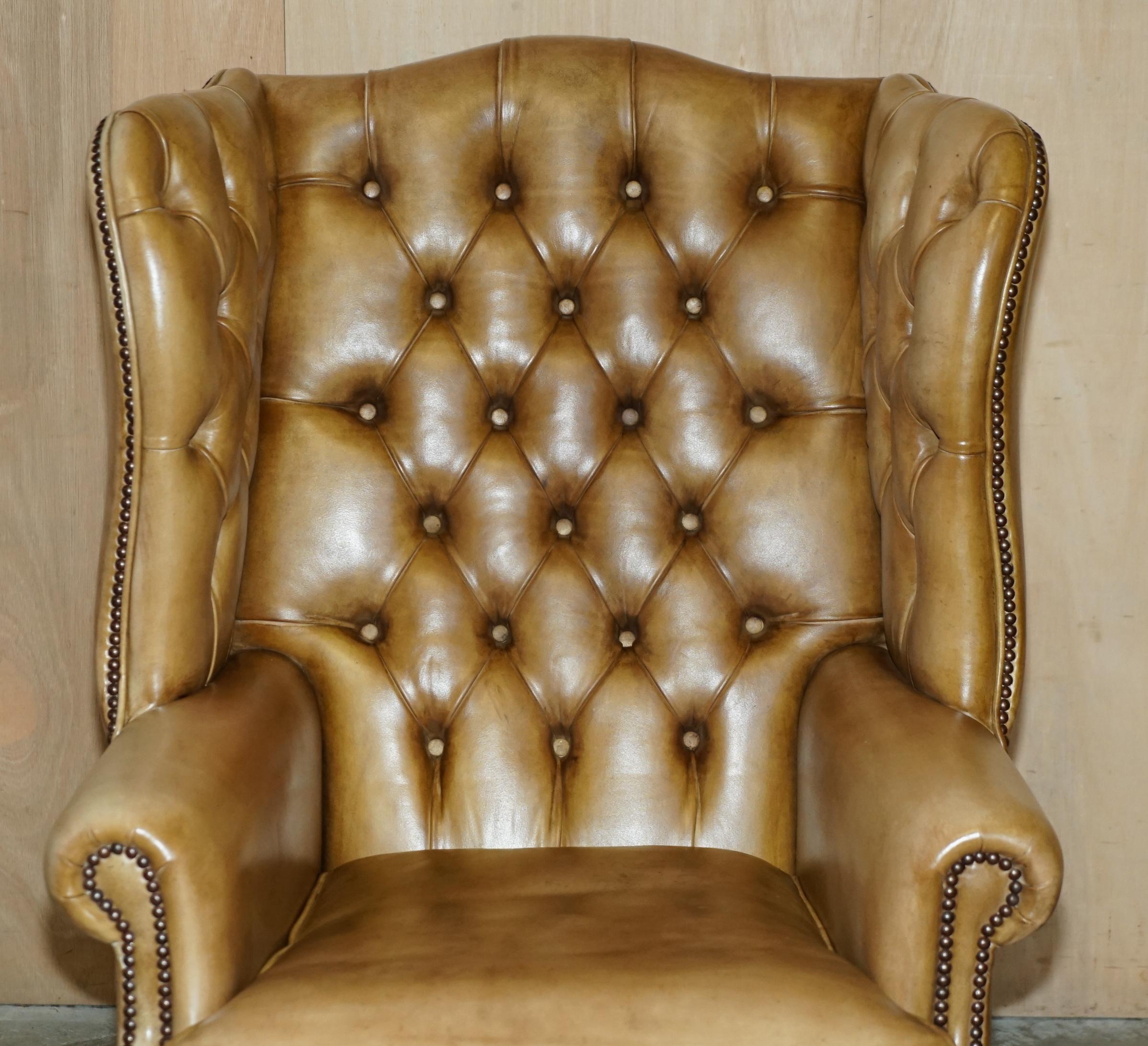 Hand-Crafted PAIR OF VINTAGE TAN BROWN LEATHER CHESTERFiELD WINGBACK CHAIRS WITH FOOTSTOOLS For Sale