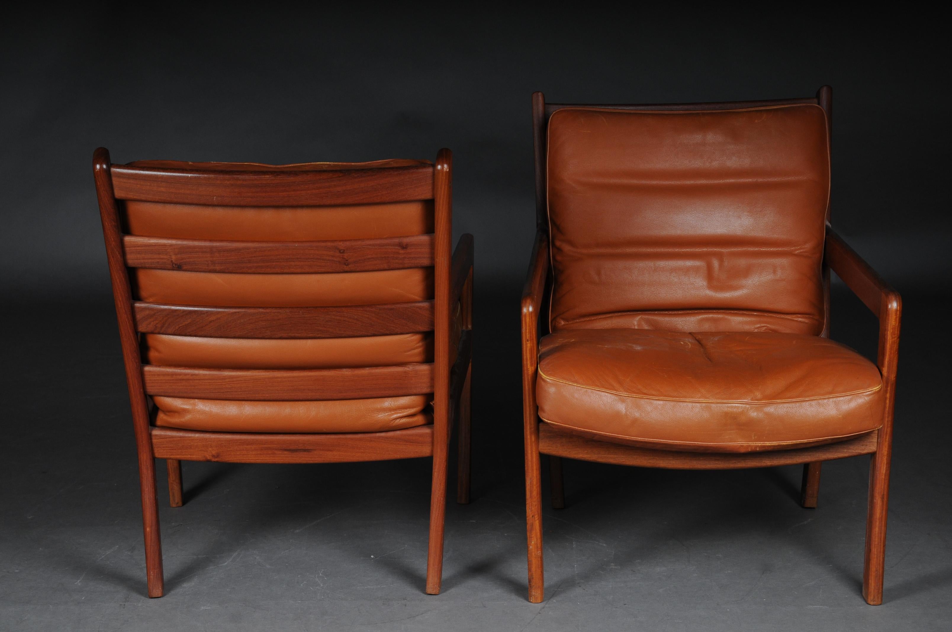 Pair of vintage teak armchairs, chairs 60s / 70s, Danish

Solid teak, simple and extremely comfortable armchair. Probably from the 60s / 70s
The upholstered chair, convincing by its simple elegance, was originally based on the design of the