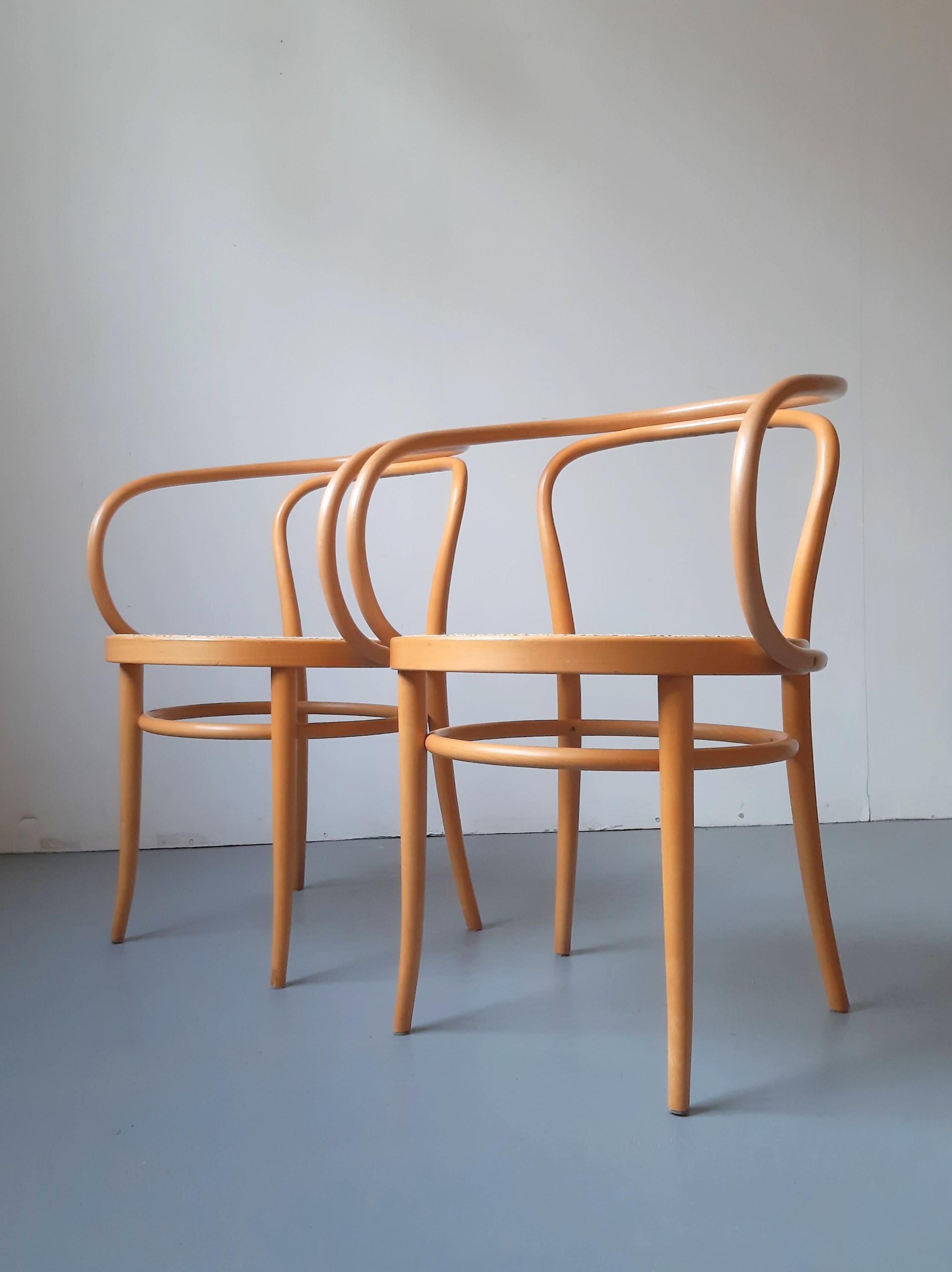 Coppia di poltrone classiche in legno di faggio modello '209', disegnate da Thonet. Queste sedie risalgono alla seconda parte del XX secolo e sono in ottime condizioni, con un'usura minima e sedili in canna sostituiti di recente. Entrambi sono