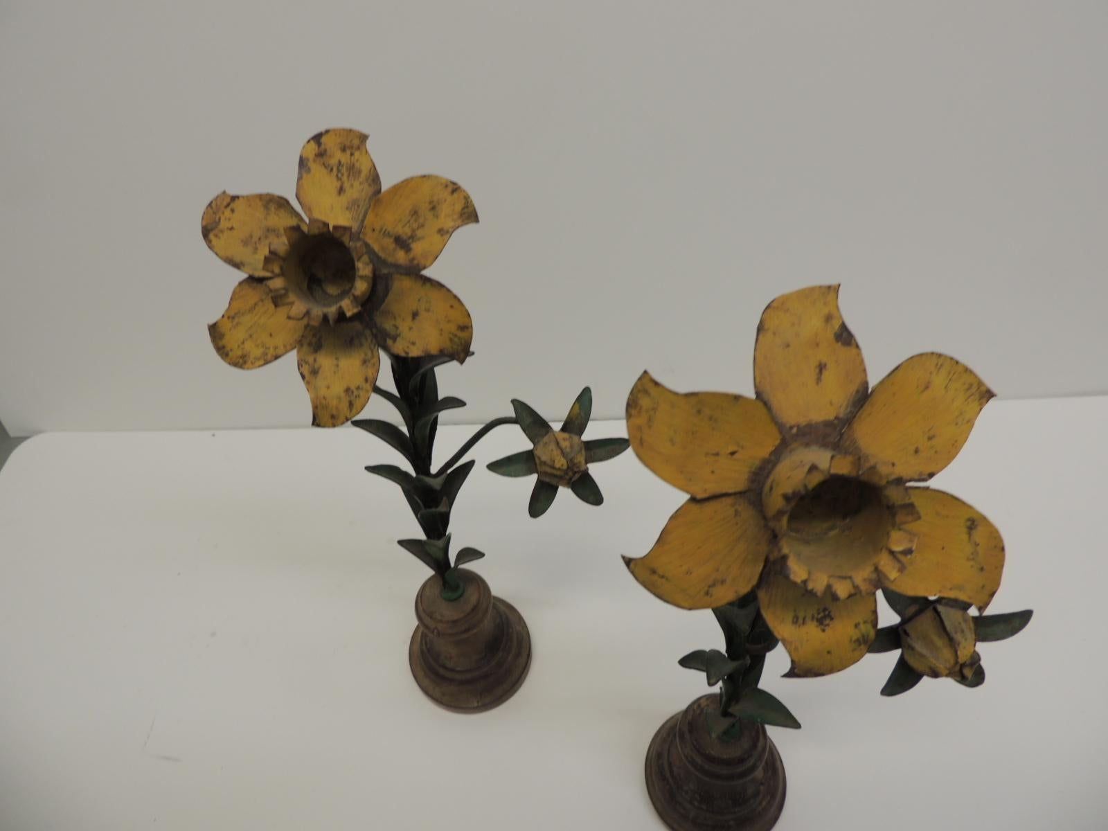 Pair of vintage tole flowers on wood round stands.
Vintage tole flowers mounted on round stands painted yellow with green stems mounted on wood round stands. Made in Italy (stamped in the bottom) for Howard Klivan Interiors.
What is Italian tole?