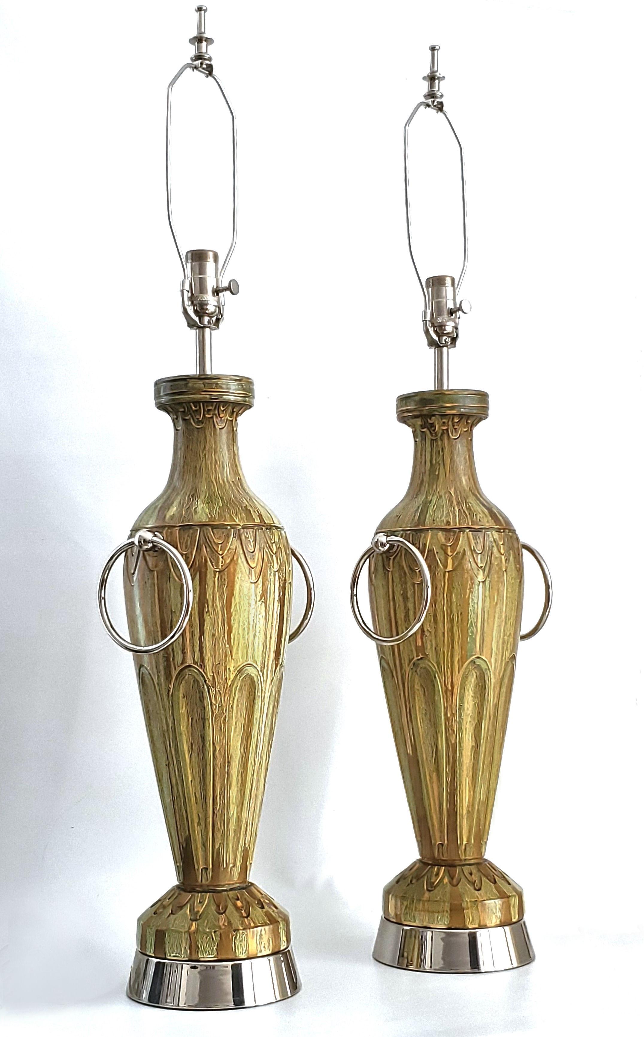 Pair of metallic gold and light green painted plaster table lamps with large nickel-plated rings, circa 1950. Both lamps are signed by the manufacturer on the back of the lamp. These lamps are authentic to the period and have been completely