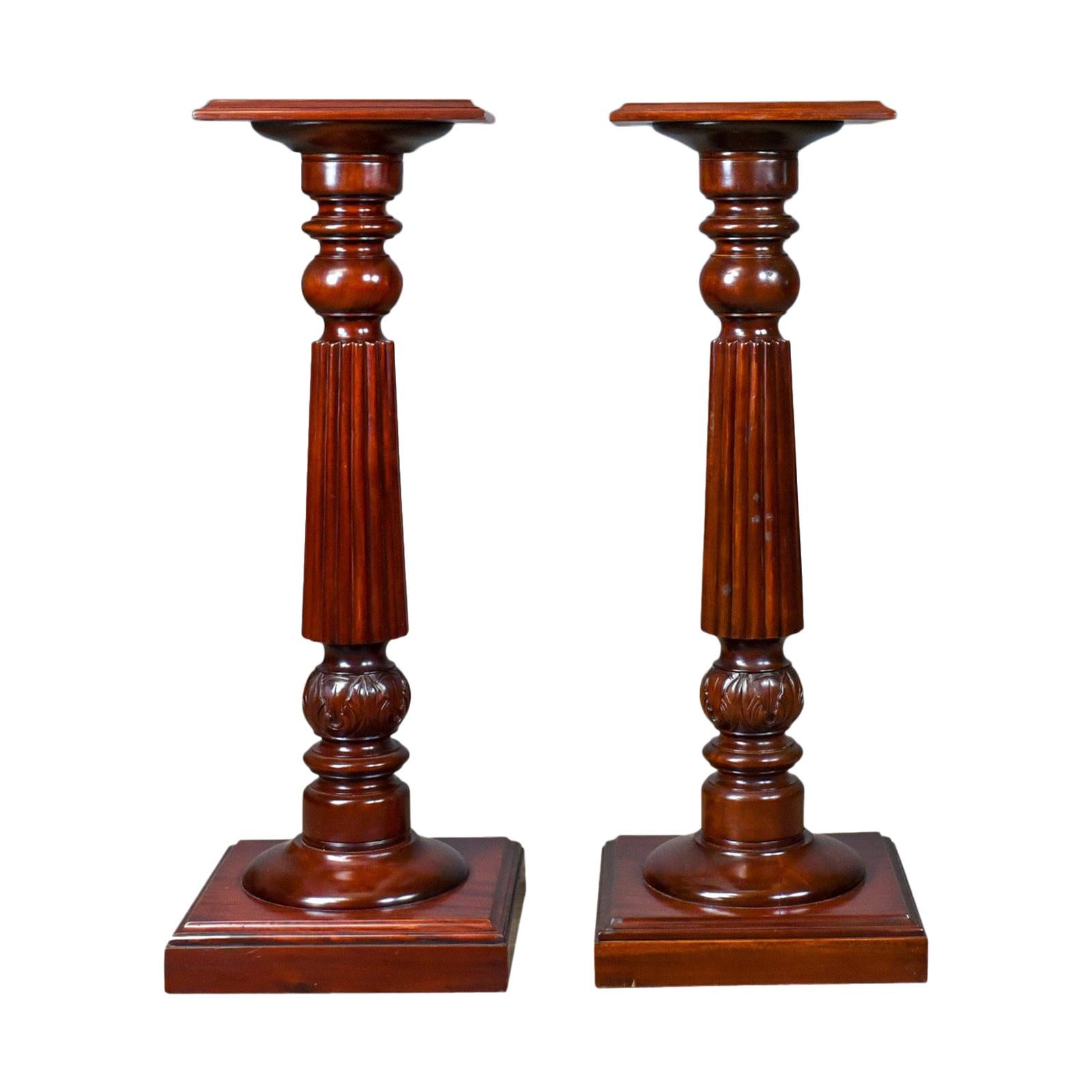 This is a pair of vintage torcheres in the Victorian taste, mahogany pedestal plant stand columns dating to the late 20th century.

Attractive color and graining to the solid mahogany
Of quality craftsmanship with a lustrous polished