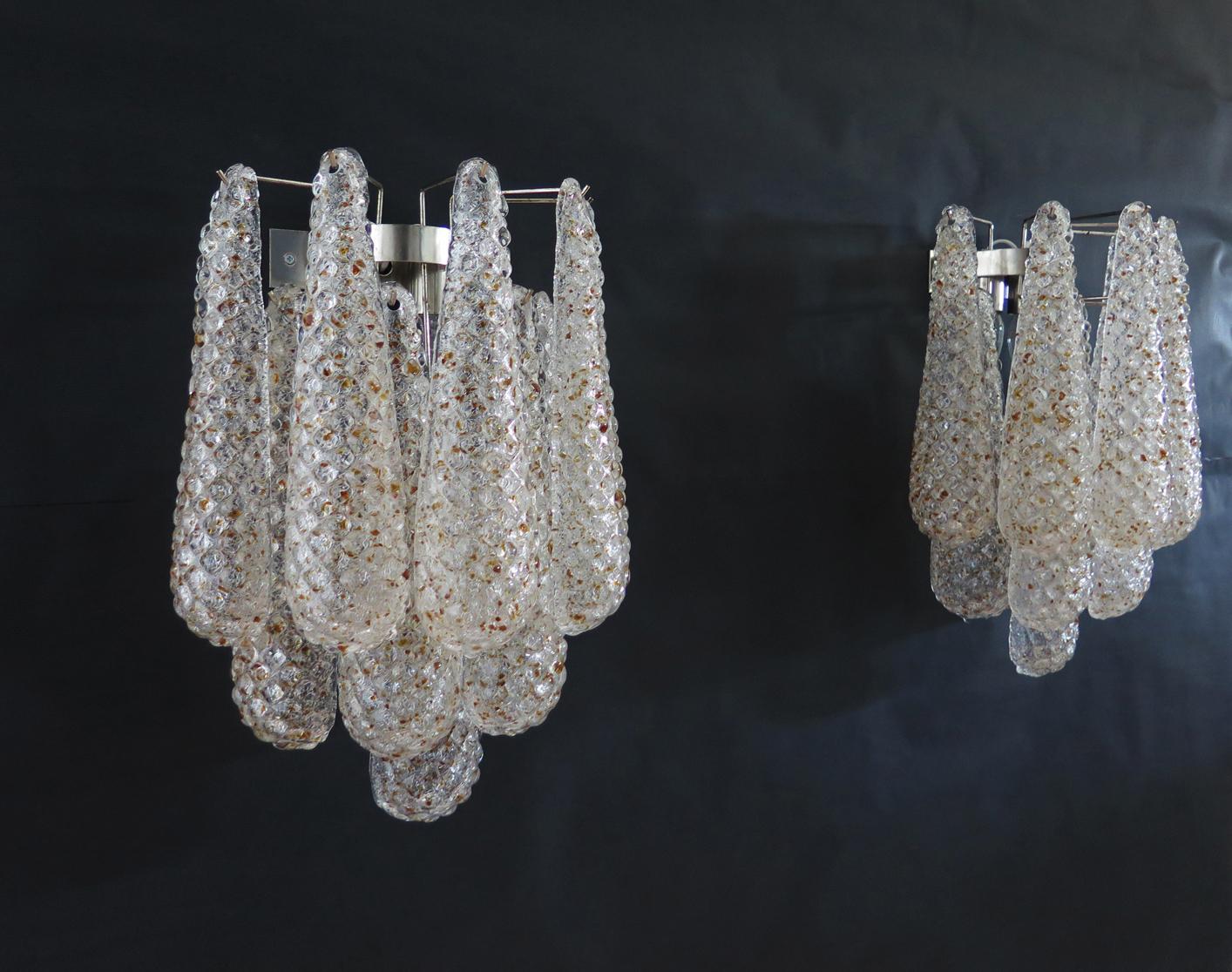 Fantastic pair of vintage Murano wall sconce made by 10 glass petals (transparent crystal, smooth outside, with transparent and amber crystal powder and then rough inside.) in a chrome frame.
Period: Late 20th century
Dimensions: 17.70 inches