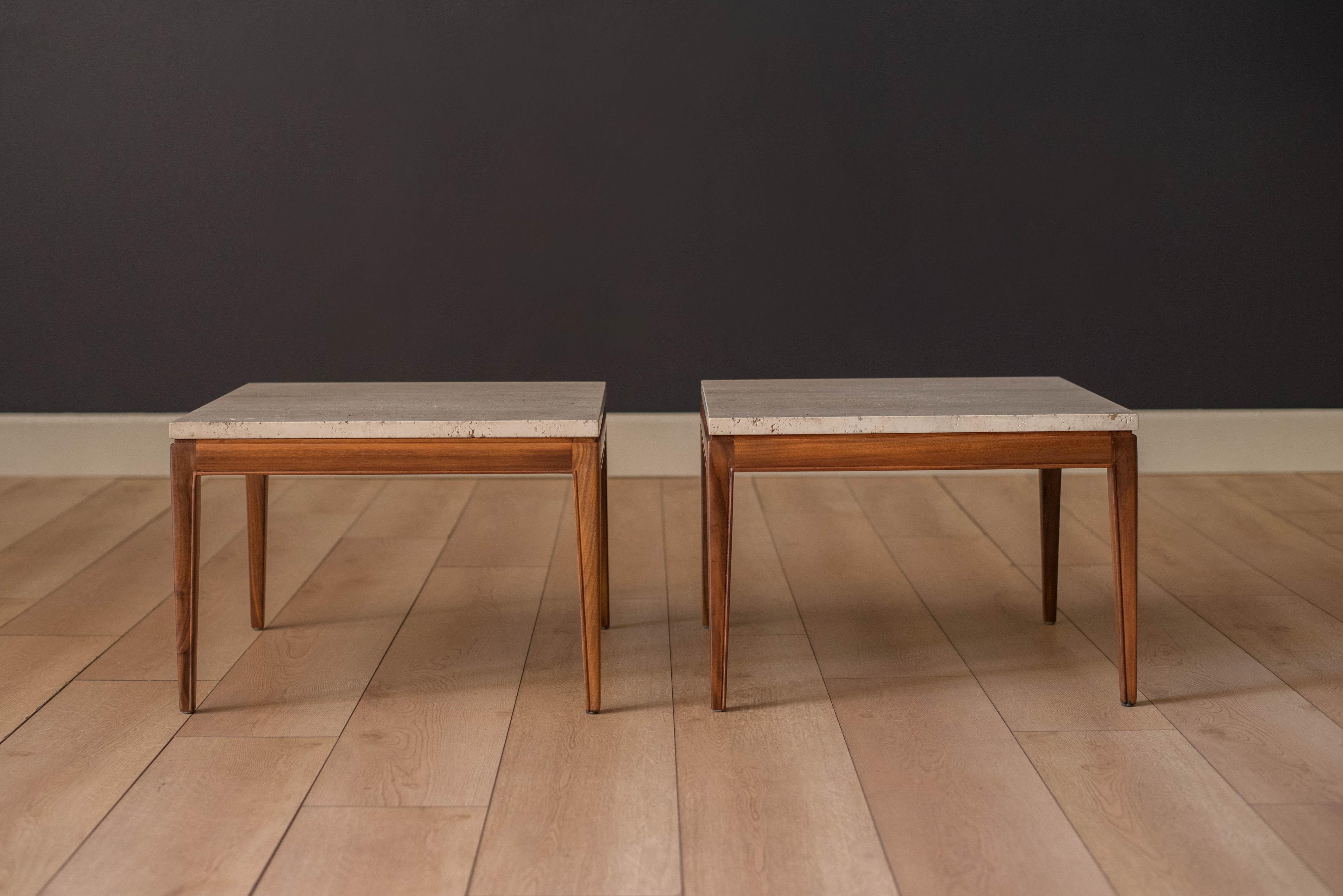 Mid-Century Modern pair of low framed walnut side tables circa 1960's. The travertine square tops display a cream and beige natural stone finish, marked made in Italy. Price is for the pair.