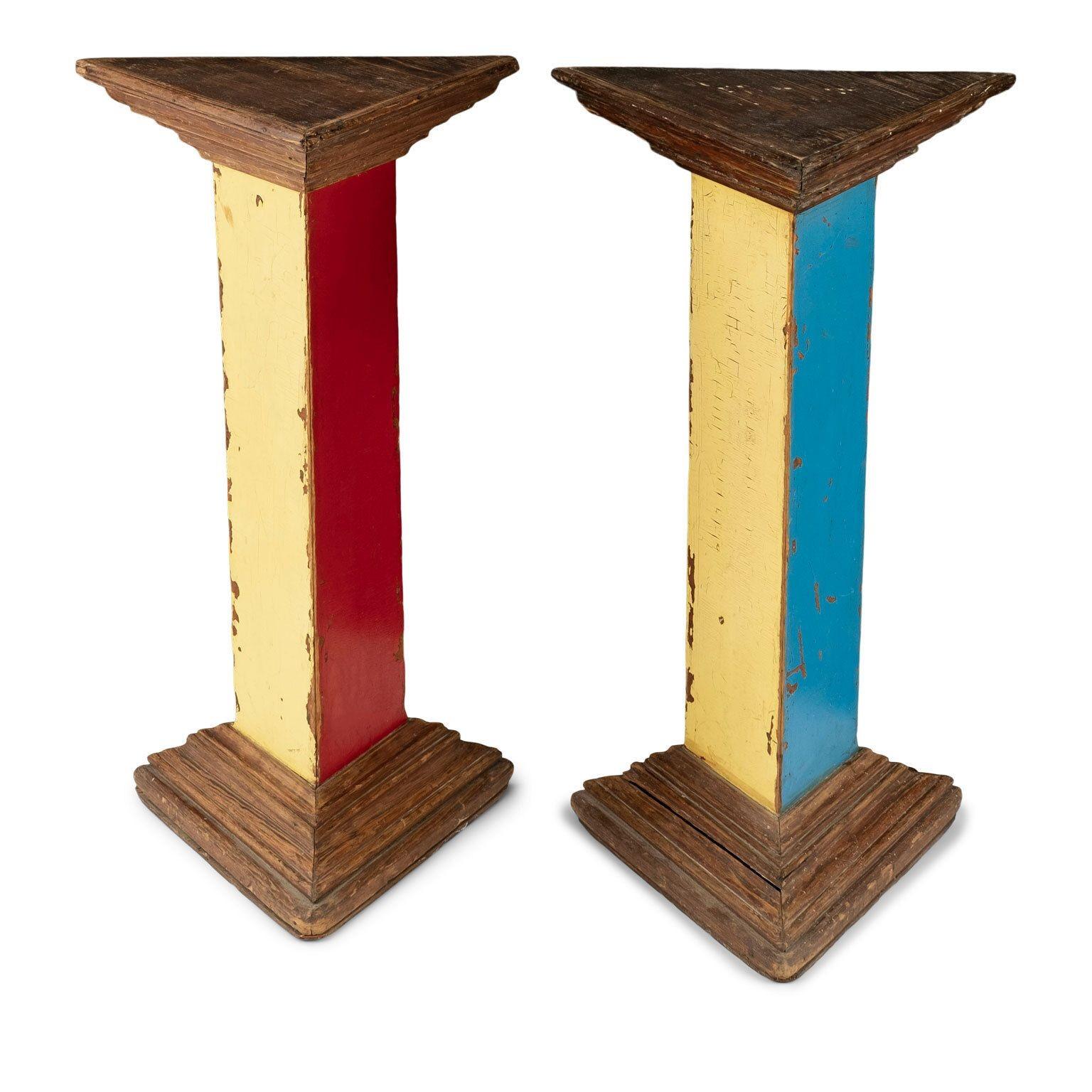 Pair of vintage triangular pedestals circa 1935-1965. Painted in primary color oil paint. Painted finish is old - not recent. Perfect as tall side table or stand. Can be cut down for lower height. Sold together and priced $3,600 for the pair.