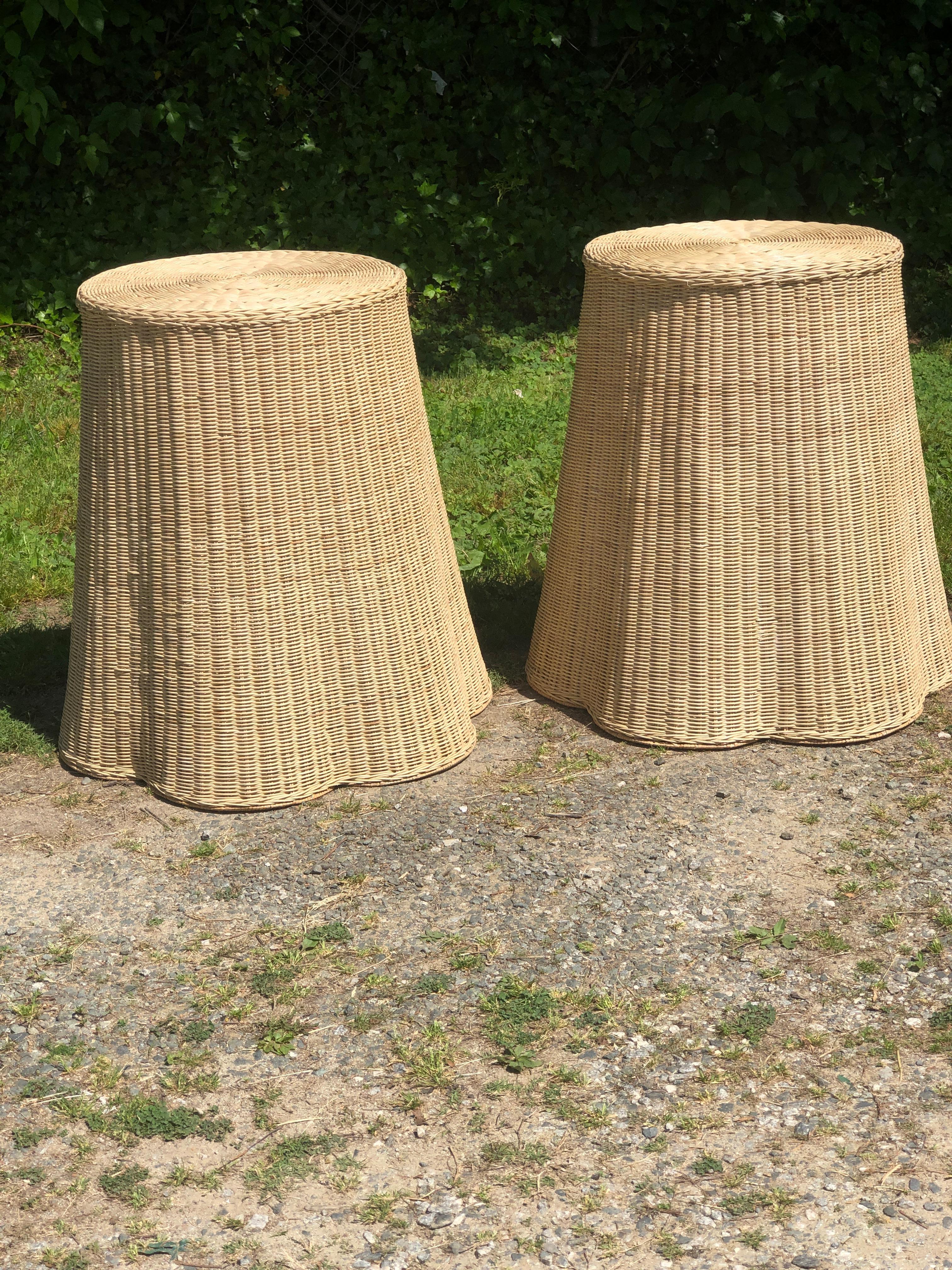 Rare pair of vintage organic trompe l’oeil natural wicker side tables or stands. These examples have a lovely draped illusion adding to their sophistication yet playfulness form. The vintage rattan has a neutral coloring  that makes it a perfect