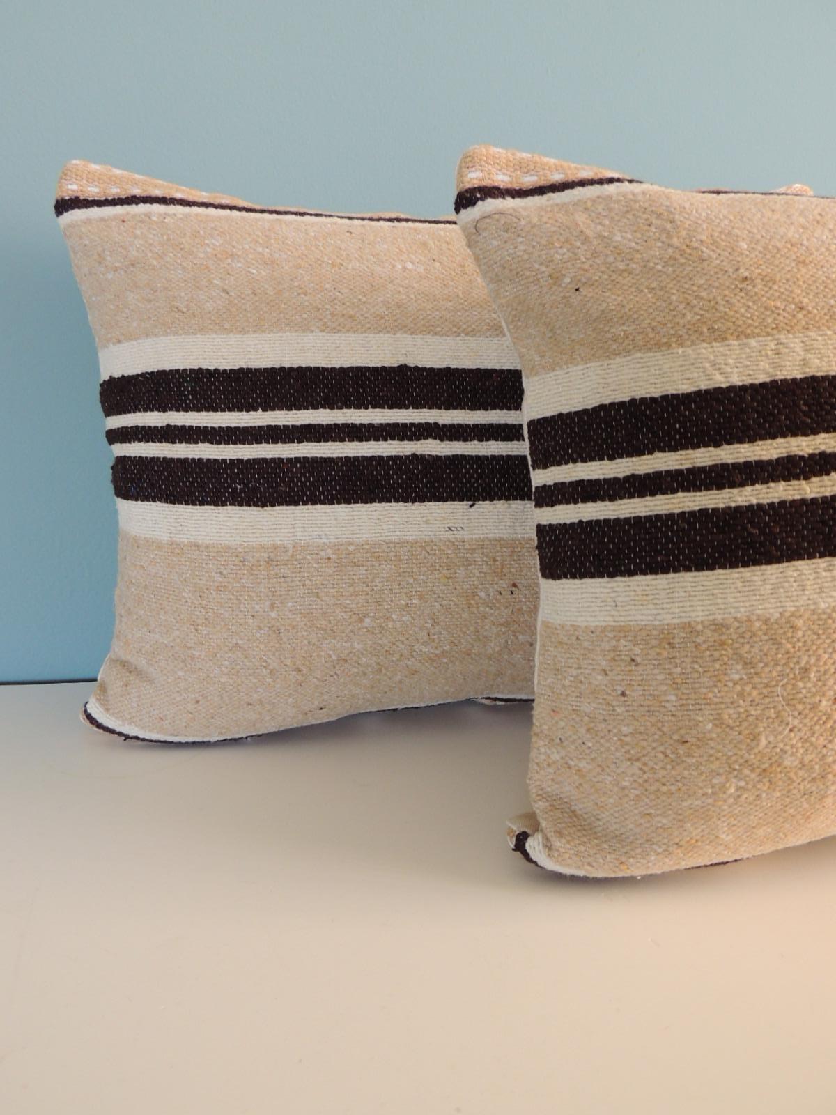 Pair of Vintage Tunisian woven brown & beige stripes decorative bolster pillows.
with cotton/linen backings. Embellished with vintage jute trim.
Decorative pillow handcrafted and designed in the USA.
Closure by stitch (no zipper closure) with