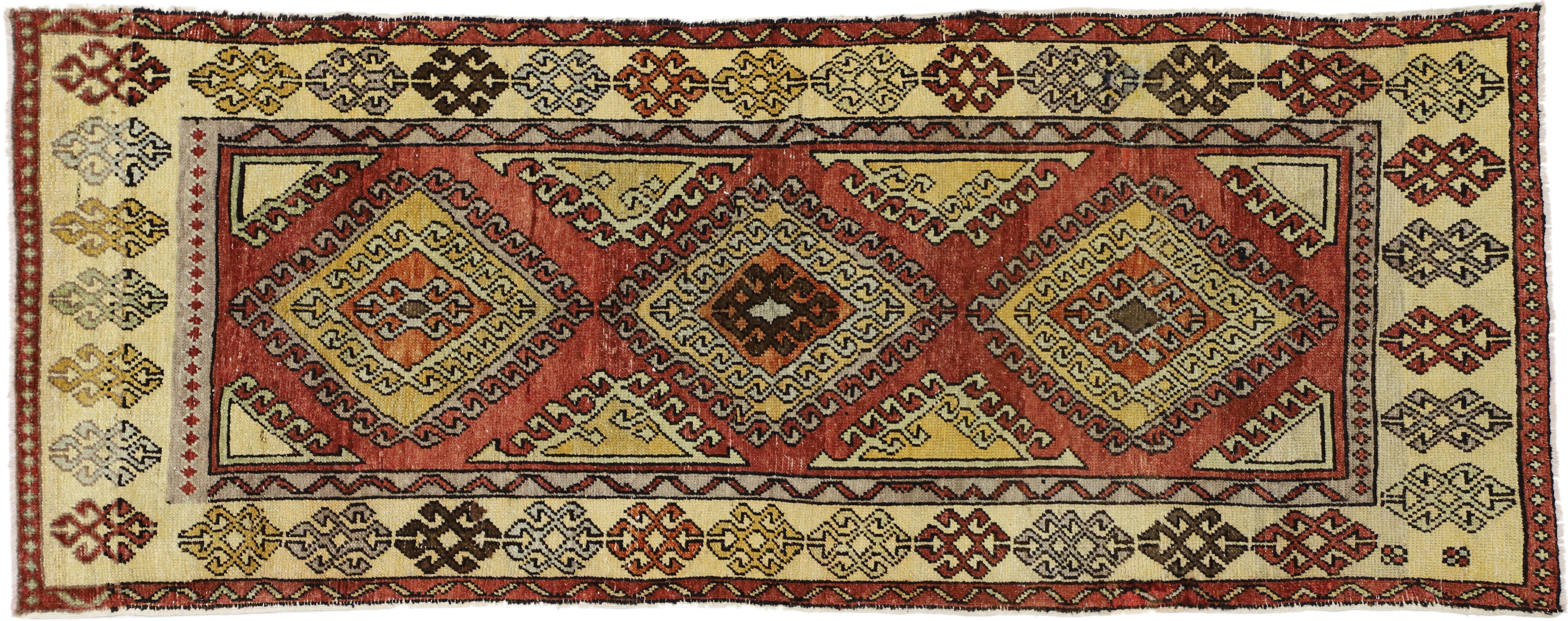 Pair of Vintage Turkish Oushak runners, Matching Tribal Style Hallway runners. This pair of nearly identical hand knotted wool vintage Turkish Oushak runner feature three layered latch-hooked medallions spread across an abrashed brick red field.