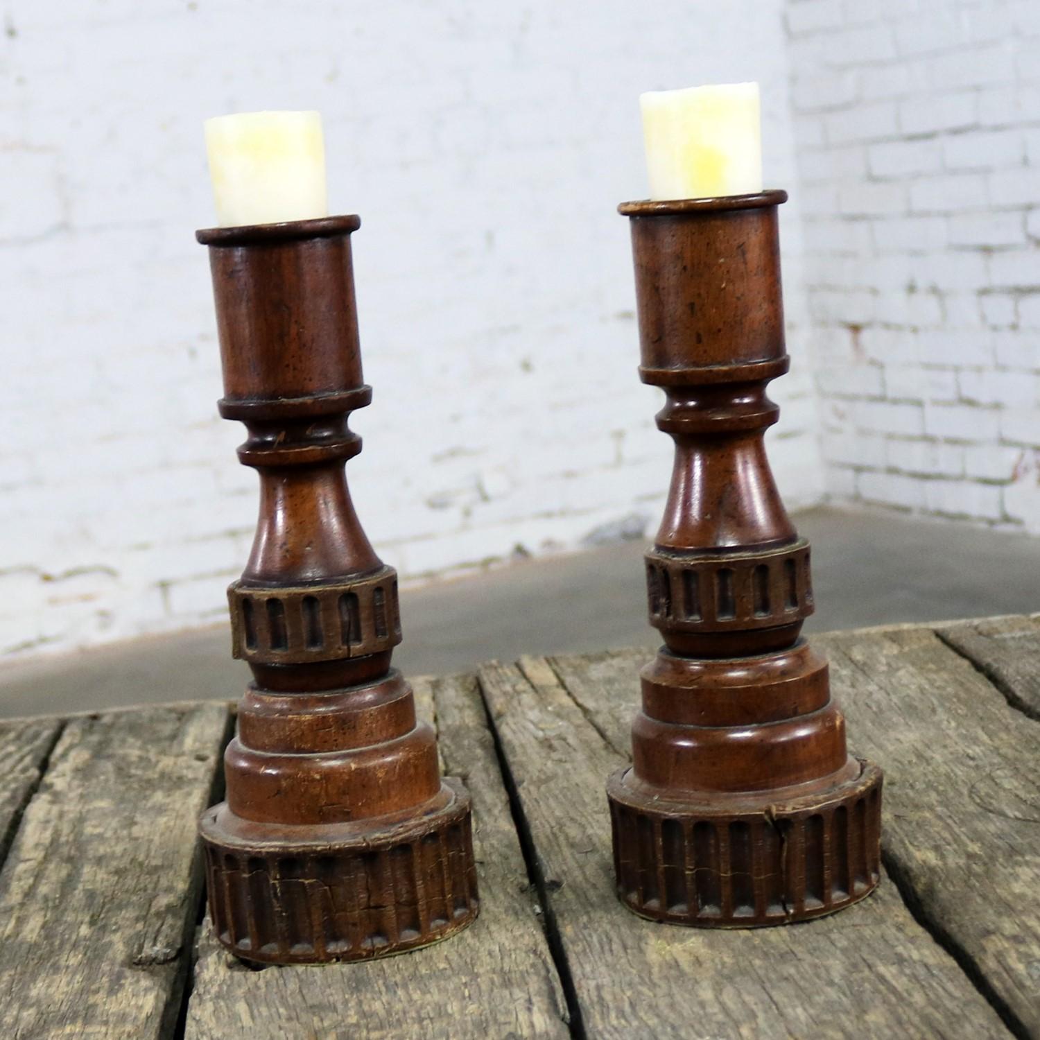 Handsome pair of distressed turned wood and composite candleholders. These are in good vintage condition with lots of nice patina, circa 20th century.

Sometimes you just need a simple pair of candlesticks whether you use them alone or combine