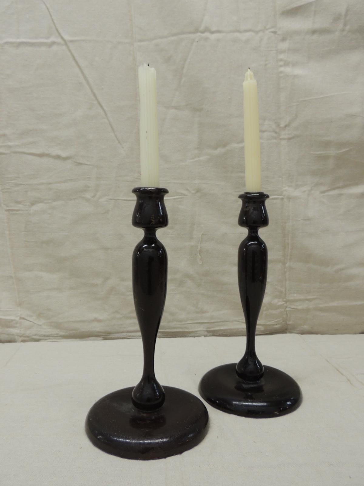 Pair of vintage turned wood candleholders in dark mahogany lacquered finish
Top of the candle designed to look like a tulipiere. (Candles not included)
Bottoms are covered with felt.
Size: 6