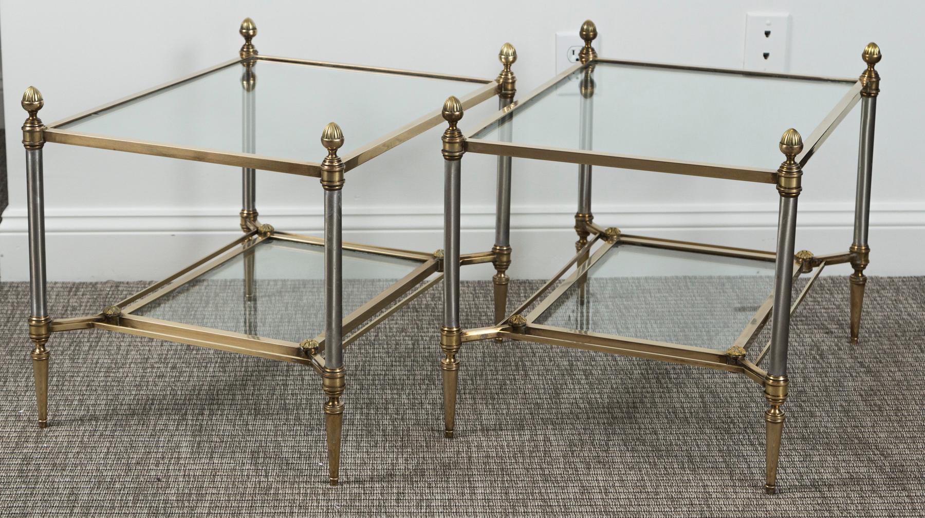 Pair of classic Maison Jansen brass and chrome two-tier tables with acorn toupie embellishments
Brass is unlacquered and hand polished, the satin chrome finish is on brass .
Note a few light surface scratches to original glass which are not