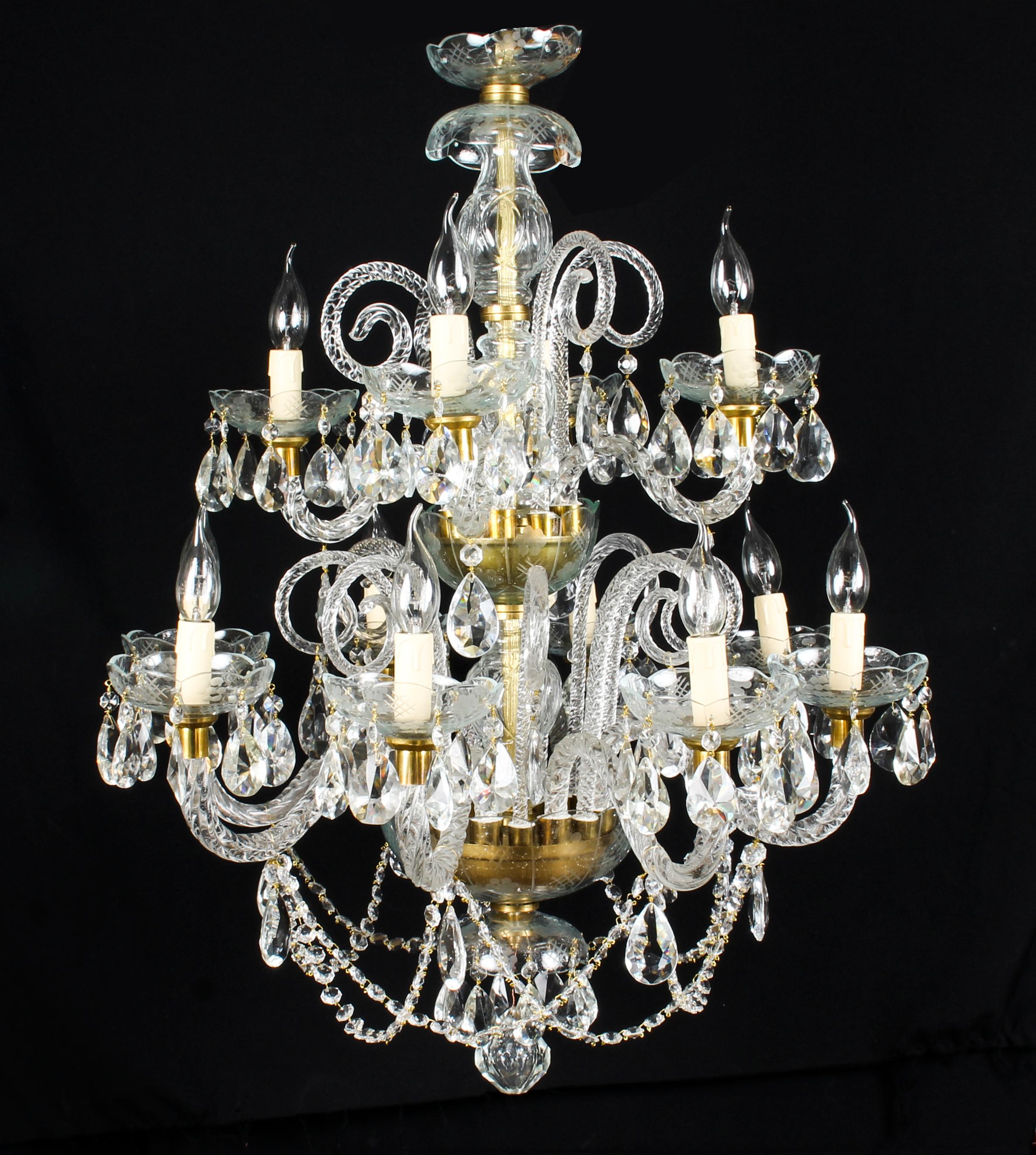 This is a beautiful pair of vintage Venetian two tier crystal chandeliers with twelve lights each and beautiful clear crystal drops, dating from the second half of the 20th century.

There are four lights on each top tier and eight on each lower