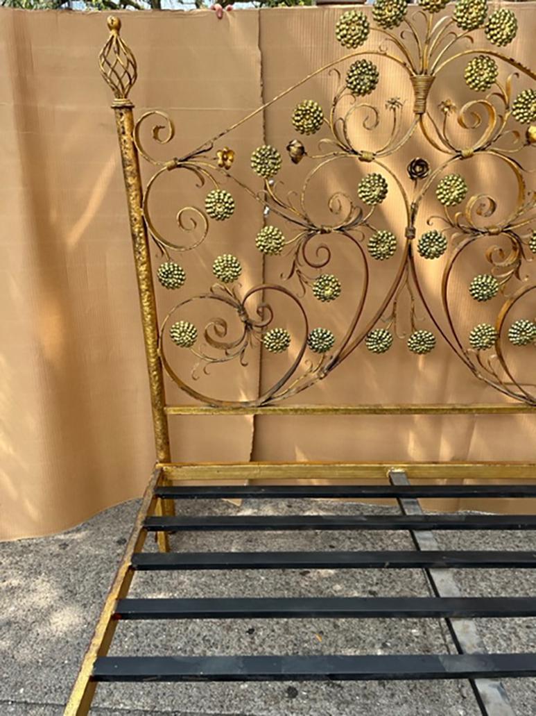 Pair of circa 1940's Venetian gilt metal beds with floral motif on head and foot boards. These fit a queen size mattress.

Measurements:
Height of heading: 65