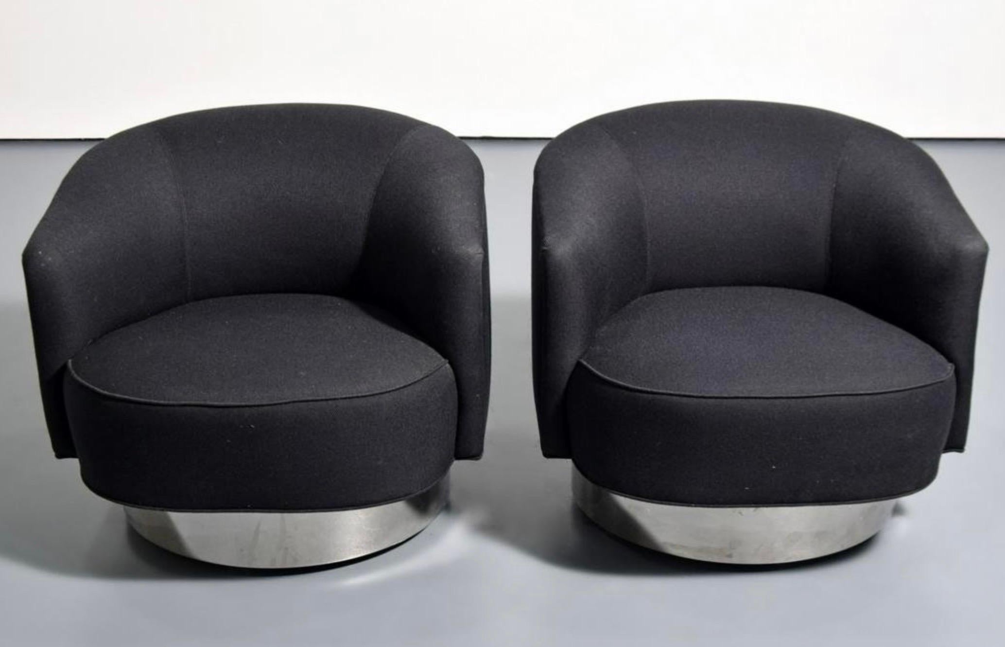 A lovely pair of vintage Vladimir Kagan swivel chairs on castors. These chairs feature chrome wrapped bases. One of the chairs retains it's original tag, which is partially obscured in the photo. The fabric is original and in good vintage condition,