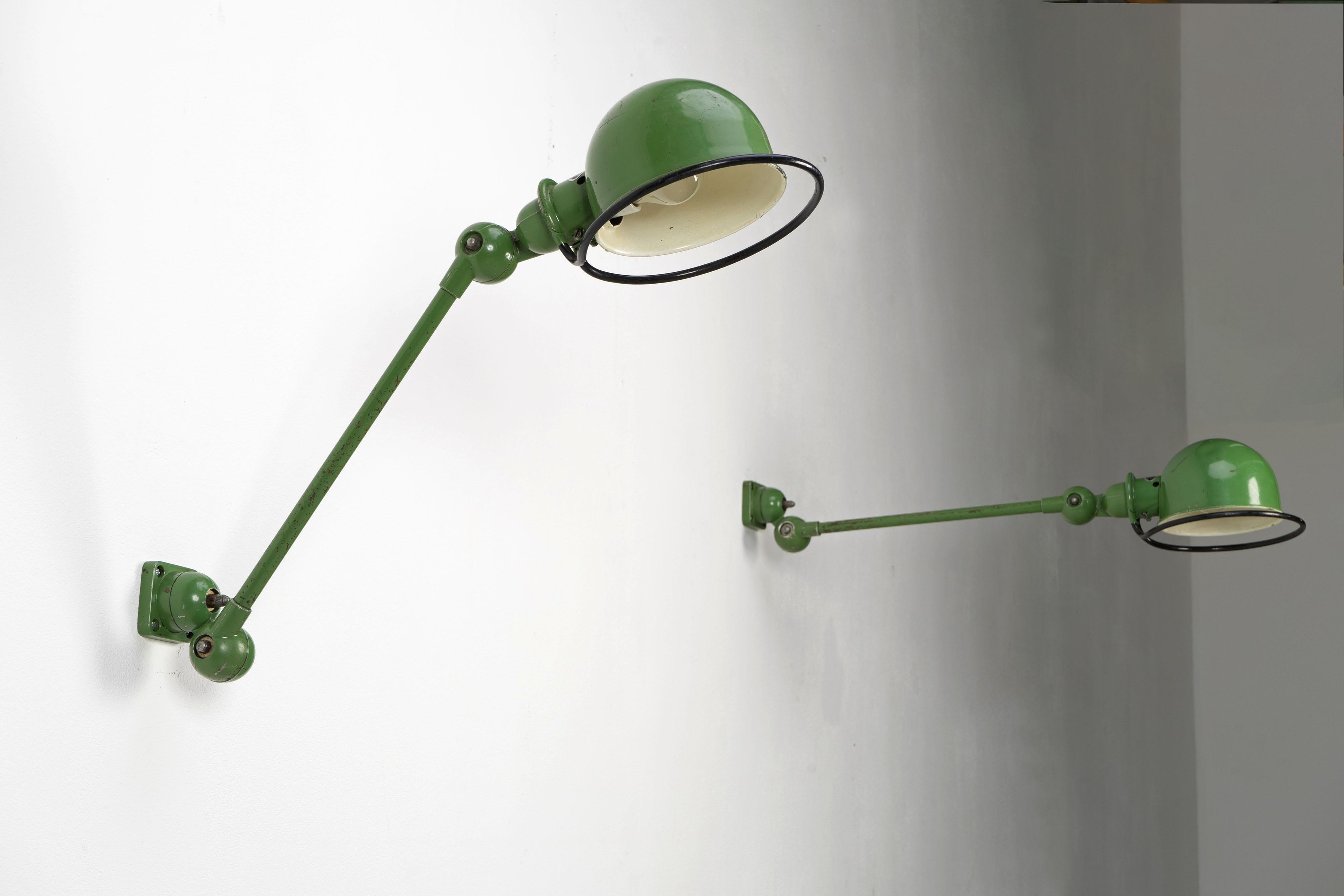 Beautiful pair of industrial wall lamps by Jielde in original lacquer. The lamps show age appropriate signs of use.