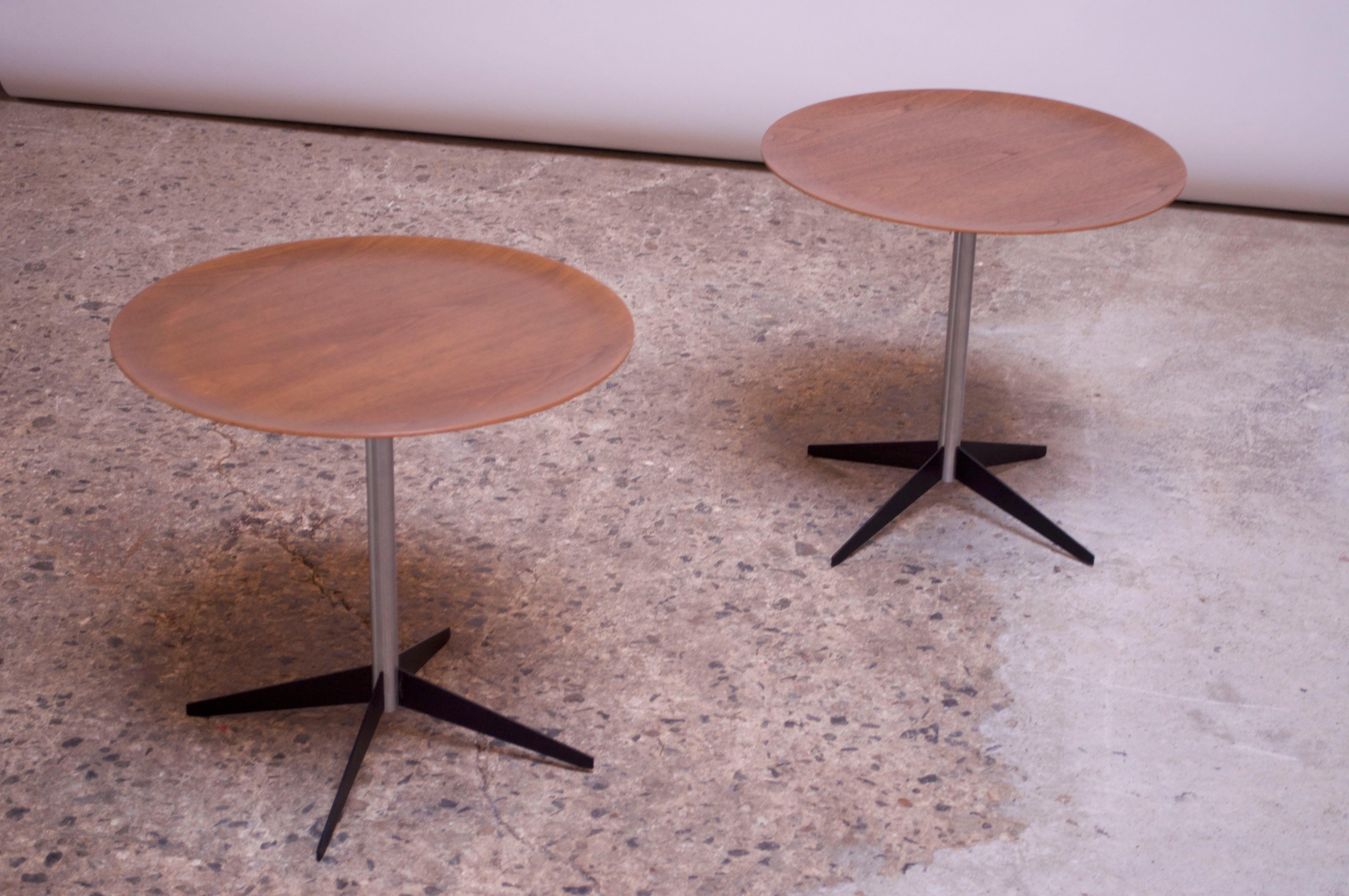 Uncommon pair of tray / drink tables designed by George Nelson & Associates for Herman Miller circa 1955. Composed of circular tops in walnut plywood with matte chrome-plated steel stems and black, enameled-steel bases. 
Excellent, vintage condition