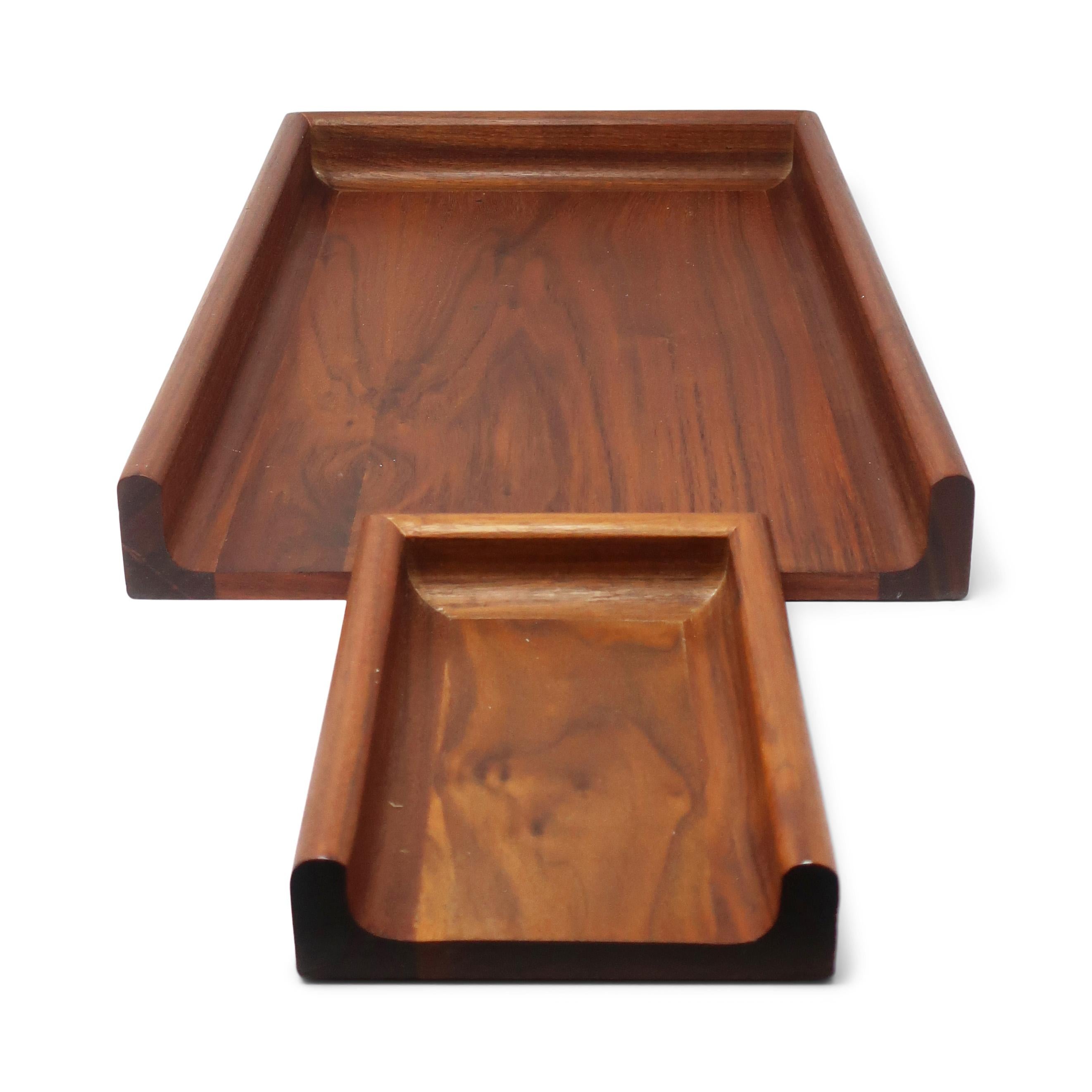A fantastic pair of vintage walnut paper trays and desk organizers by Peter Pepper Products. One tray is large enough to be used for standard size paper while the other is small enough for note paper, letters, or even business cards. Together they