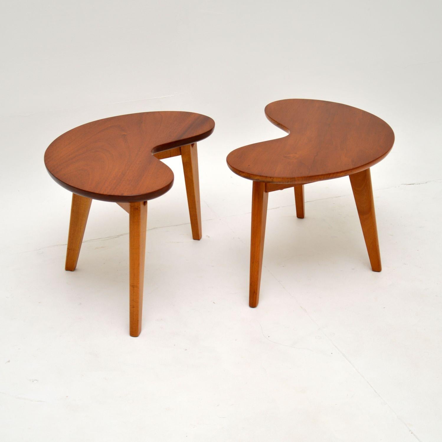 A stunning pair of vintage walnut kidney shaped side tables. These were made in England, they date from the 1950-1960’s.

The quality is fantastic, they are sturdy and are a very useful size. The shape is perfect for use as end tables either side