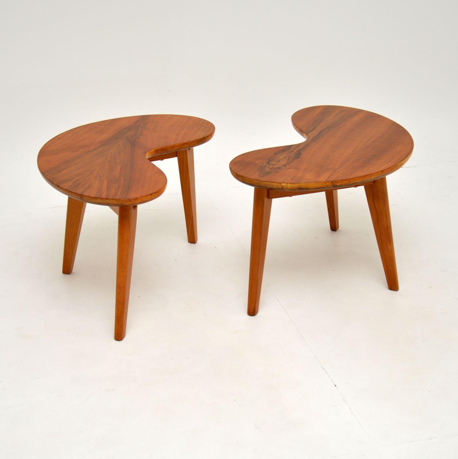 A stunning pair of vintage walnut kidney shaped side tables. These were made in England, they date from the 1950-1960’s.

The quality is fantastic, they are sturdy and are a very useful size. The shape is perfect for use as end tables either side