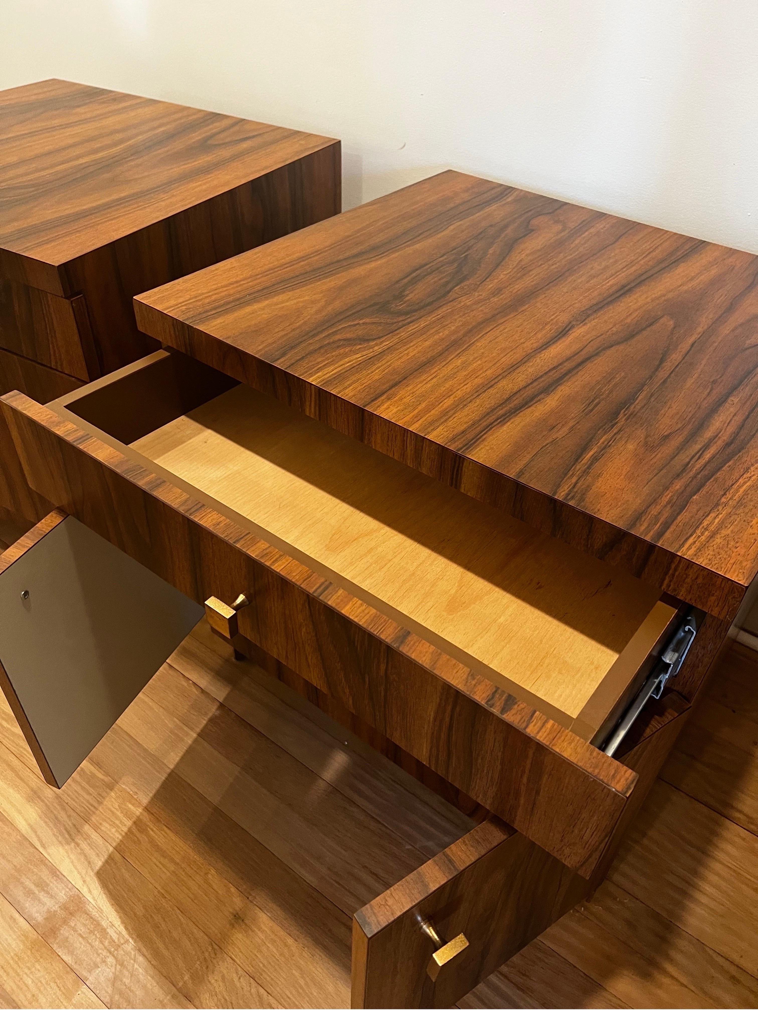 Striking pair of  SOLID cube Mid Century Modern Nightstands.  
Rosewood veneer with laminate lining.  The finish is wrapped all the way around so they can float in room and look good from all angles.  
Has single drawer with two doors offering lots