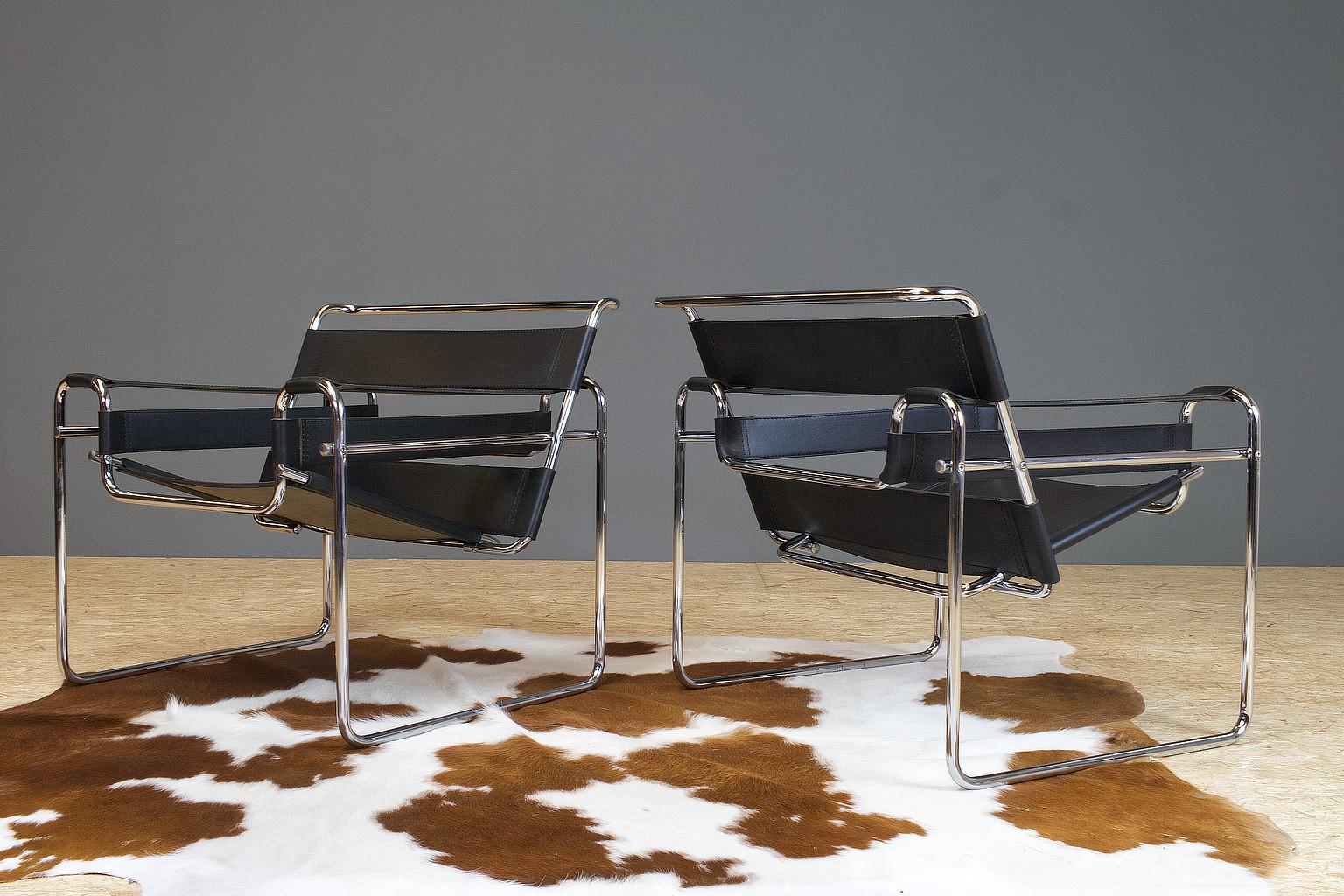 Iconic Marcel Breuer black leather Wassily chairs, circa 1970s-1980s. There are no manufacturer hallmarks. Probably Italian made. The black leather is in excellent condition and the chrome is in really good shape as well, there are some small parts