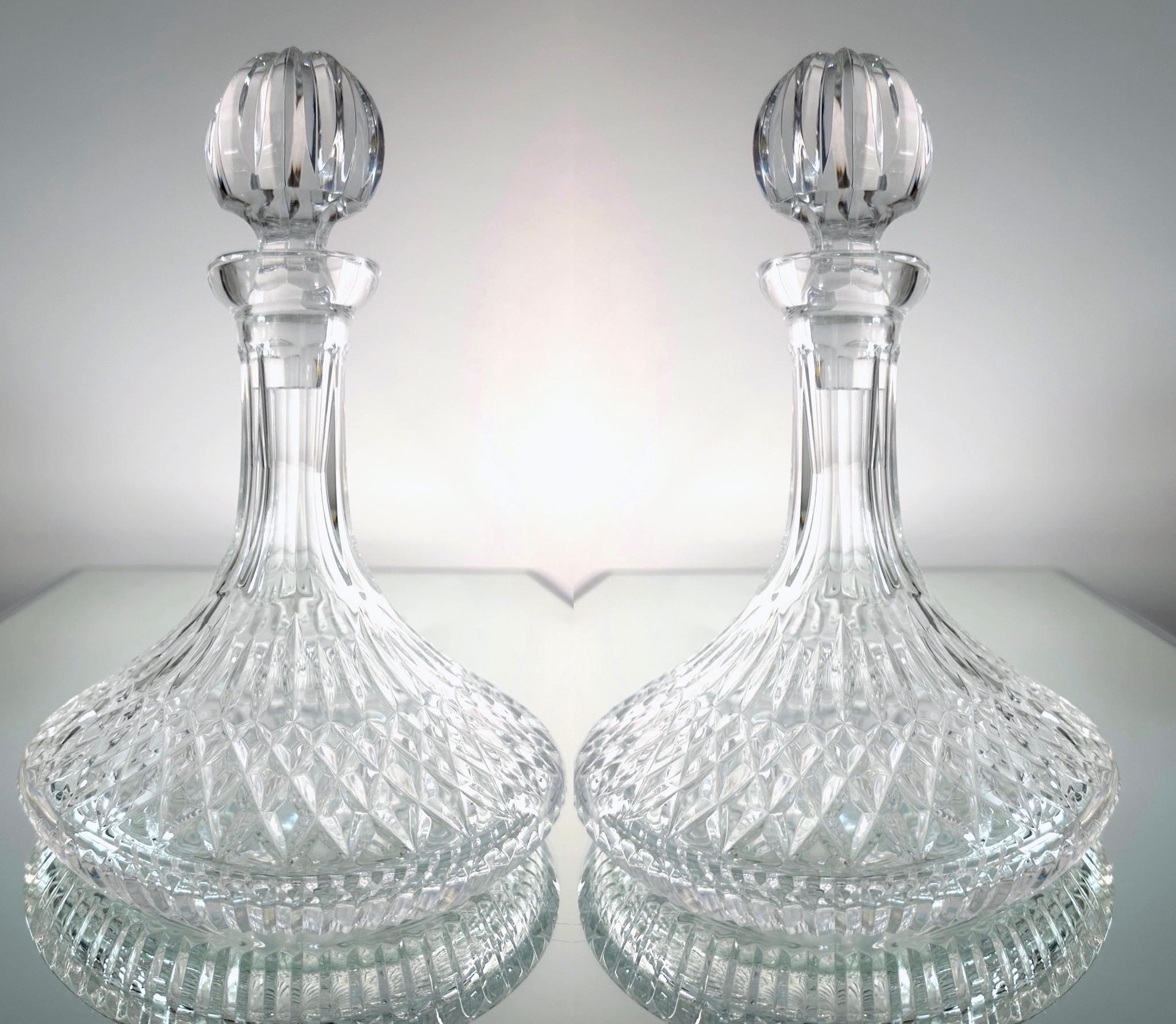 Pair of stunning vintage ships decanters by Waterford Crystal from the classic Lismore Series, first introduced in the early 1950's. Handcrafted and mouth-blown lead crystal featuring brilliant prismatic diamond cuts with etched designs throughout.