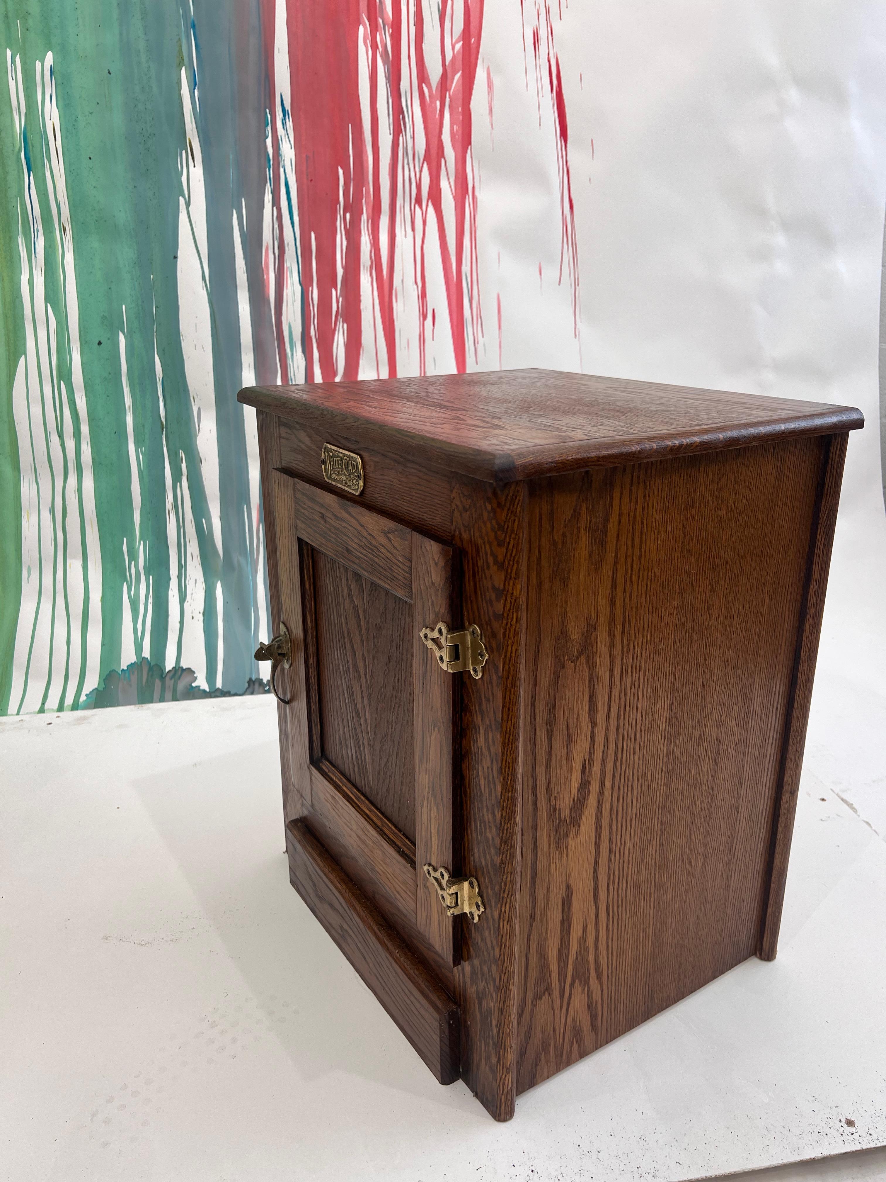 Pair of Vintage White Clad Oak Ice Box Single door Cabinet, great as nightstands or side tables.
Unique brass latching hardware and handle. 

25”h 
20 1/4” L 
16 1/2” D 
Internal dimension: 
14 1/8 D 
18 1/8 W 
17” H
