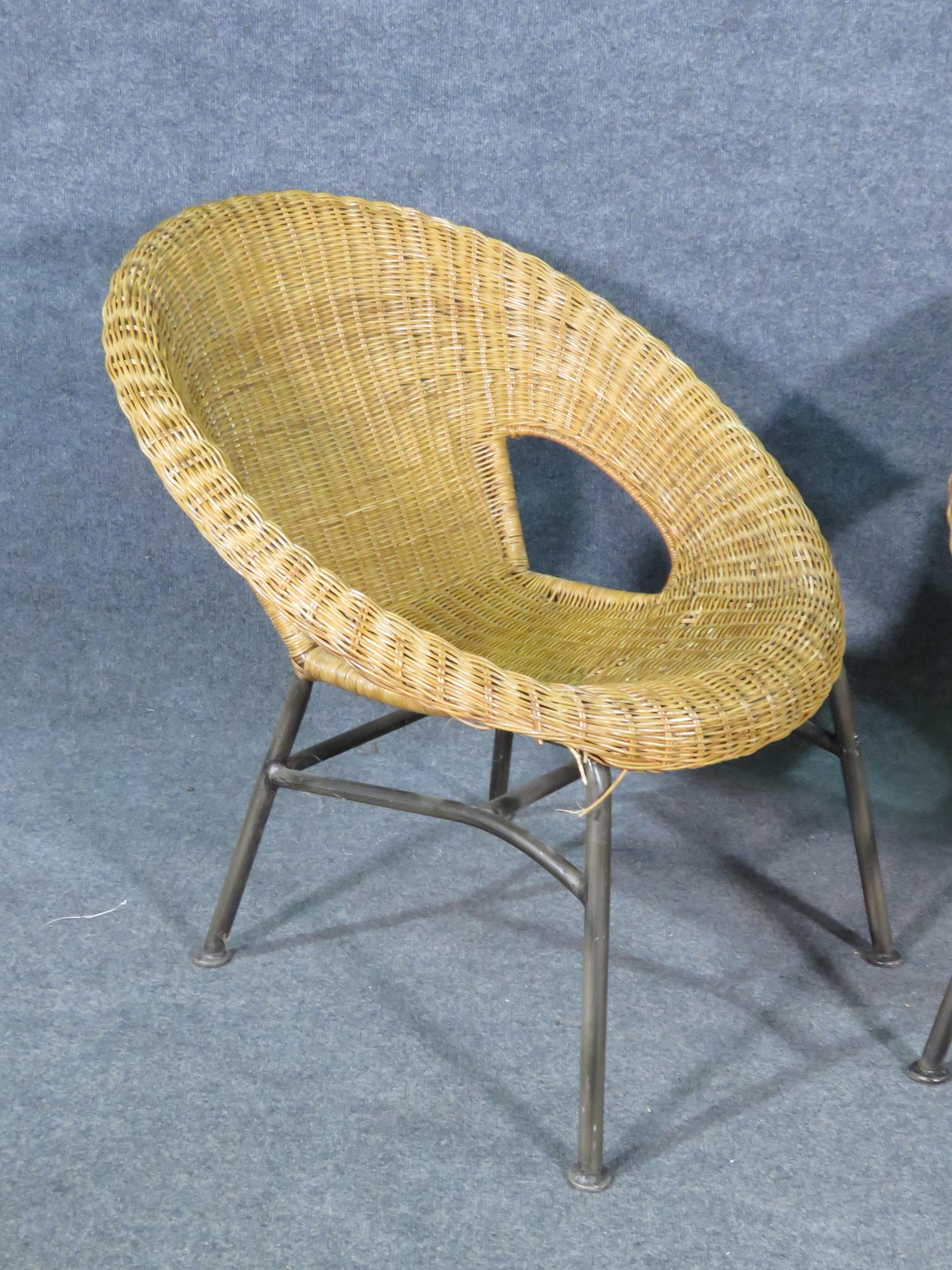 Confortable et élégante paire de chaises panier en osier vintage. Combinant un cadre métallique et un design arrondi en osier, ces chaises sont parfaites pour s'asseoir à l'intérieur ou à l'extérieur. Veuillez confirmer la localisation de l'article