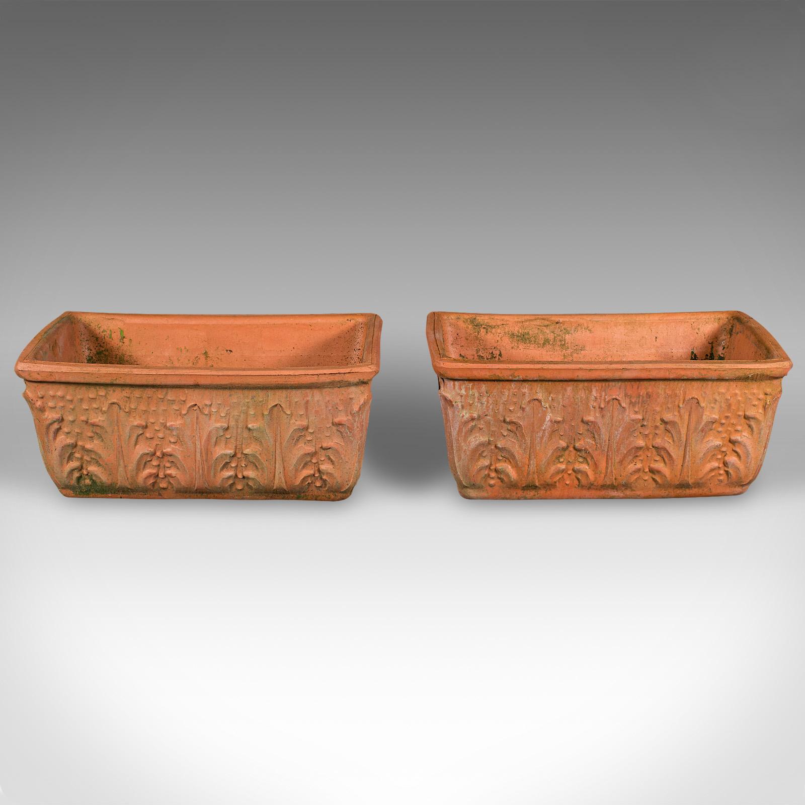 This is a pair of vintage windowsill planters. An Italian, terracotta window box jardiniere, dating to the late 20th century, circa 1970.

Charmingly petite duo, ideal for a chic apartment or townhouse
Displaying a desirable aged patina with a